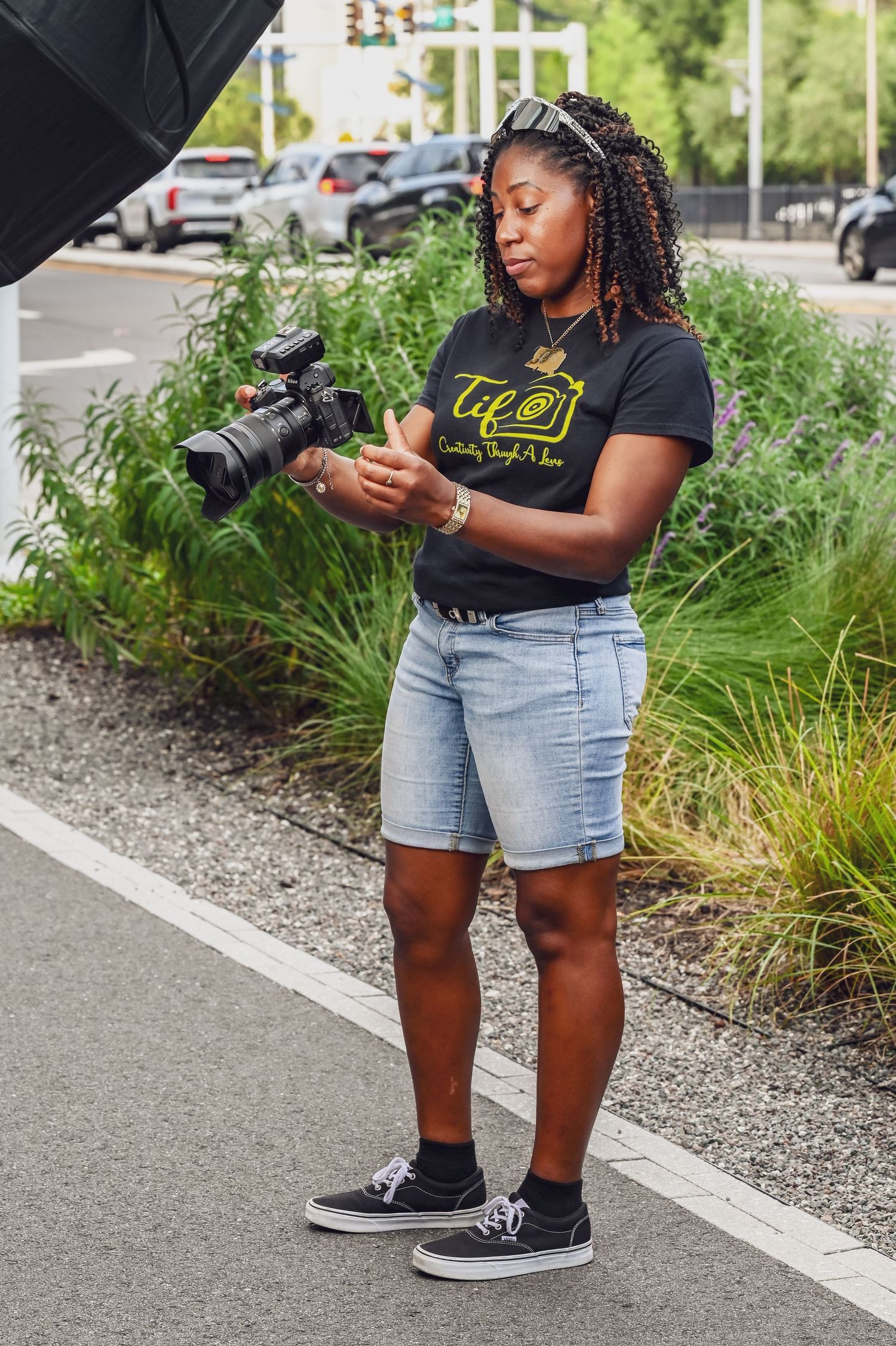 Tiffany Jones smiling and holding a camera during a portrait session in Tampa, Florida, photographed by Blue Lime Photo Media
