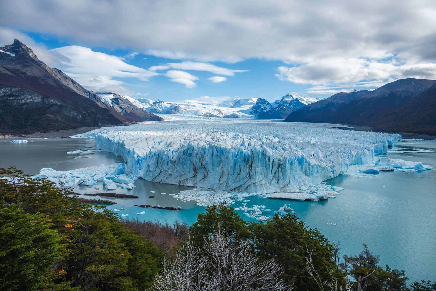 Aerial view of Perito Moreno Glacier with turquoise icebergs floating in Argentino Lake, Patagonia, Argentina.