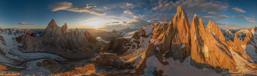 Breathtaking 360-degree panorama of Patagonia's Fitz Roy and Cerro Torre at golden sunset with climbers visible.