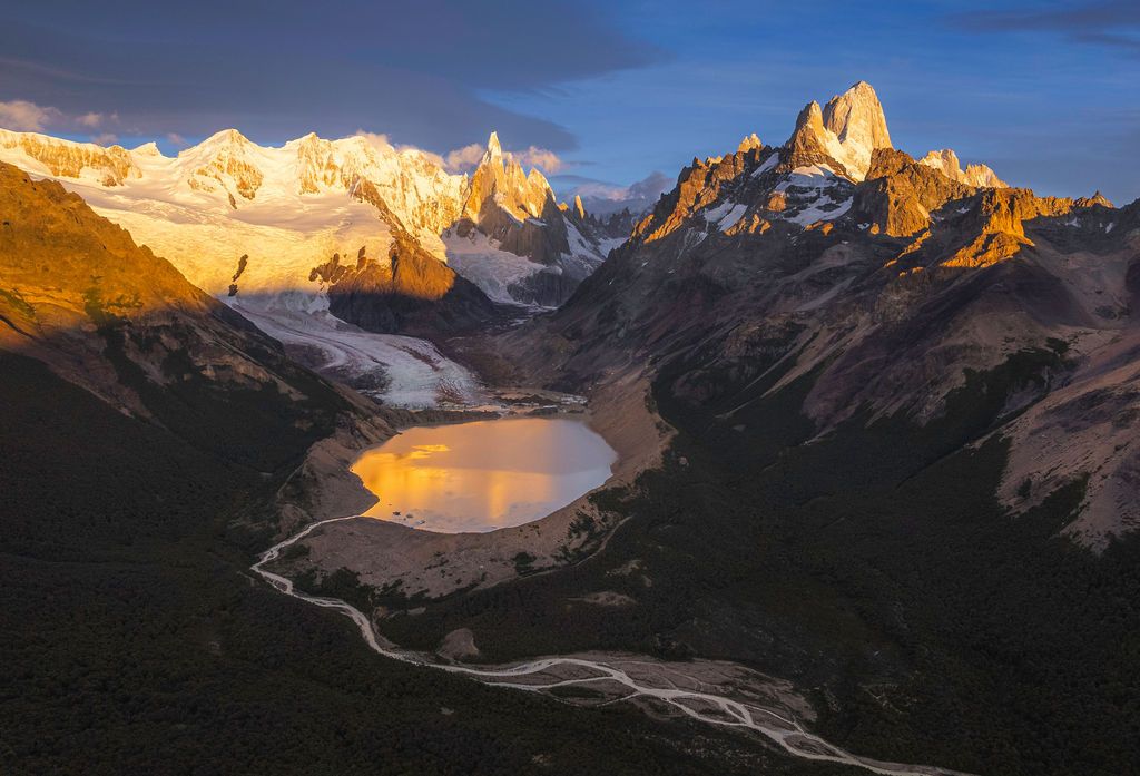 Aerial golden hour view of Laguna Torre and Mount Fitz Roy in Los Glaciares National Park.
