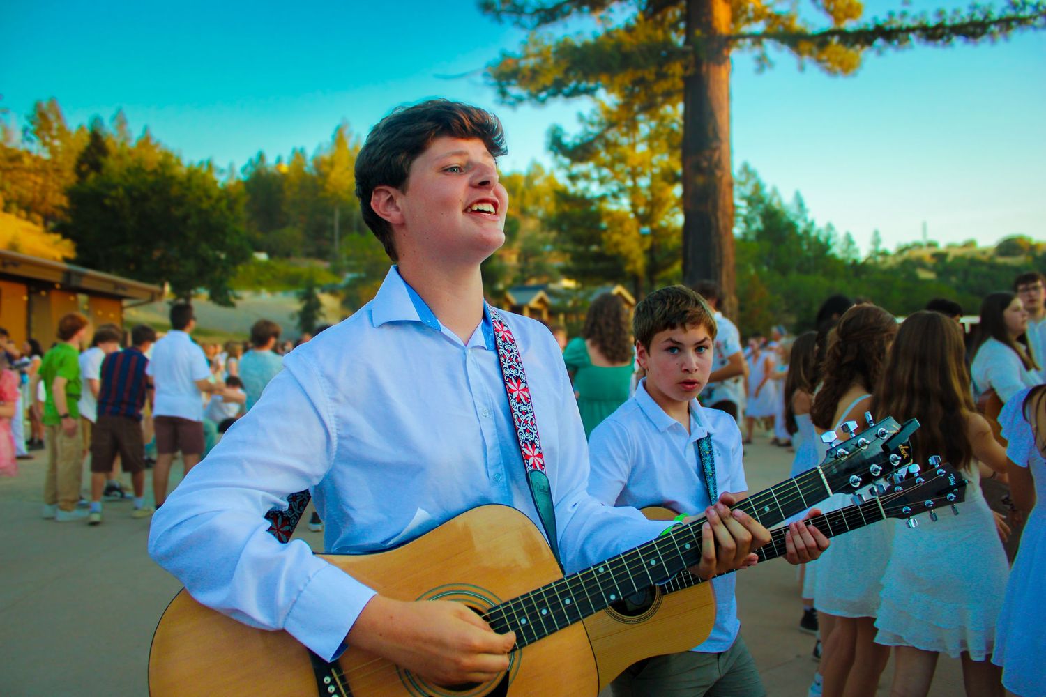 A boy playing the guitar.