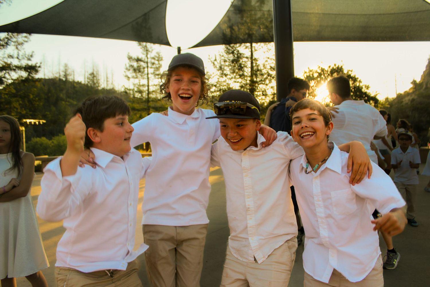 Four boys jumping up and down.