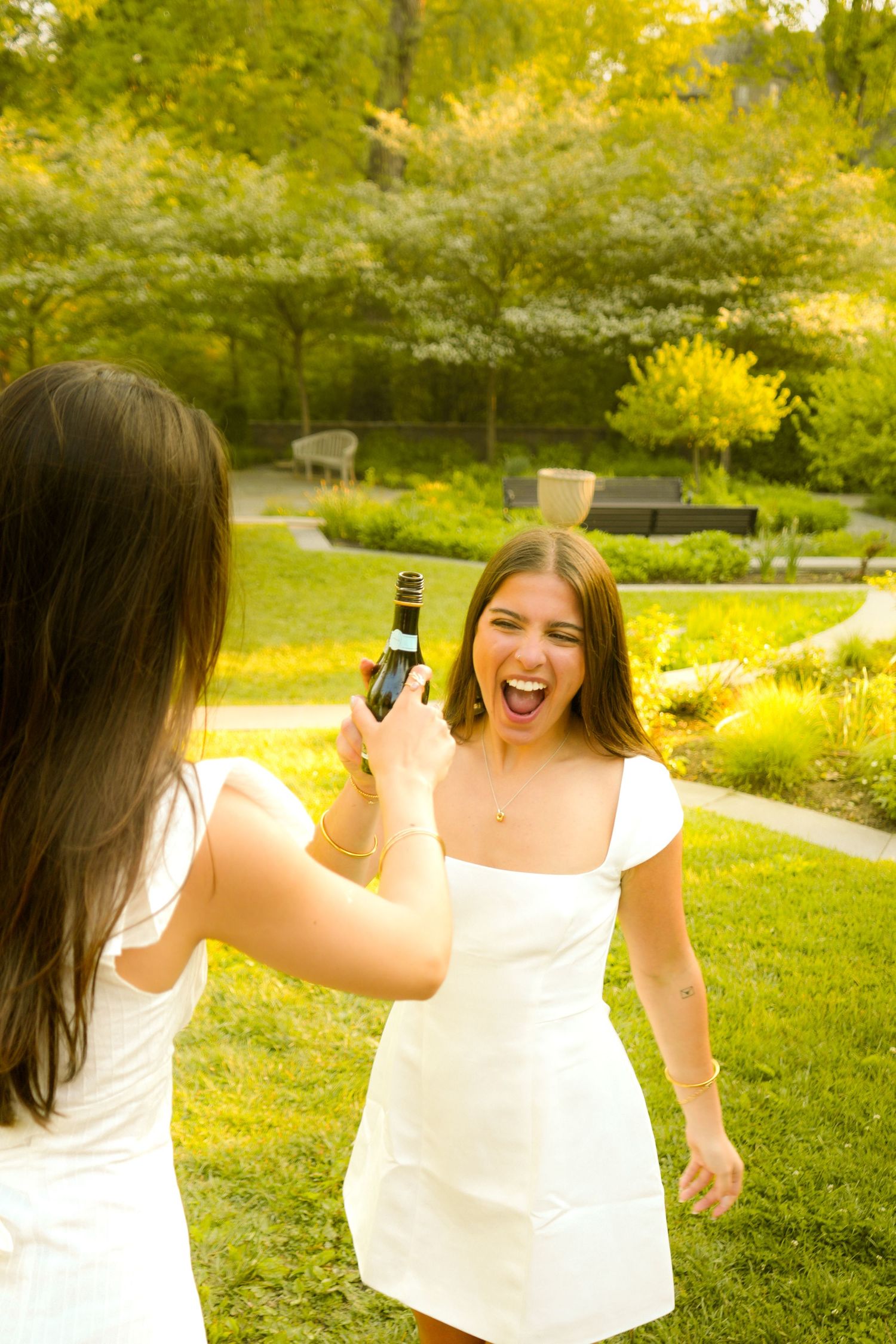 Two women cheers-ing.