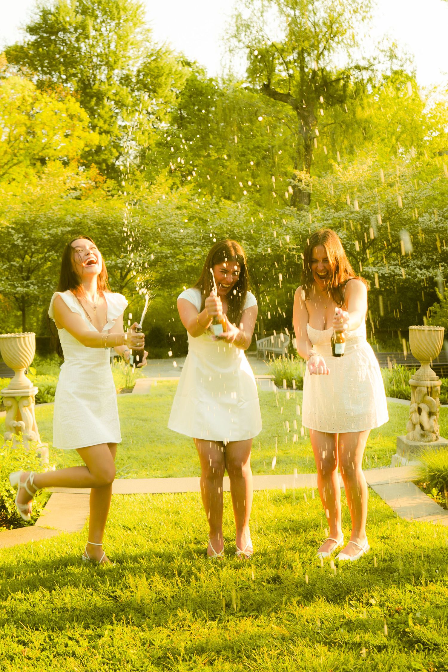 Three woman spraying champagne.