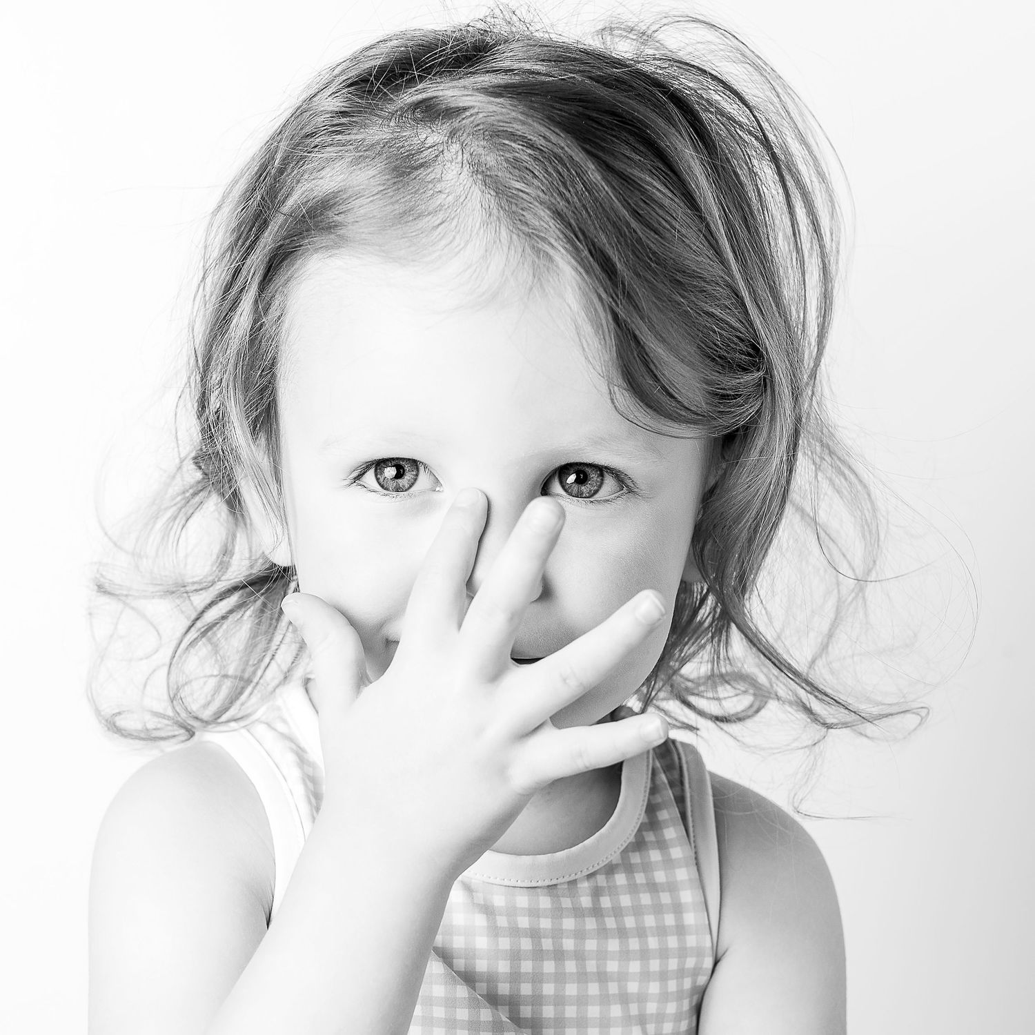 Black-and-white portrait of smiling young girl at Classic Littles children's portrait session.