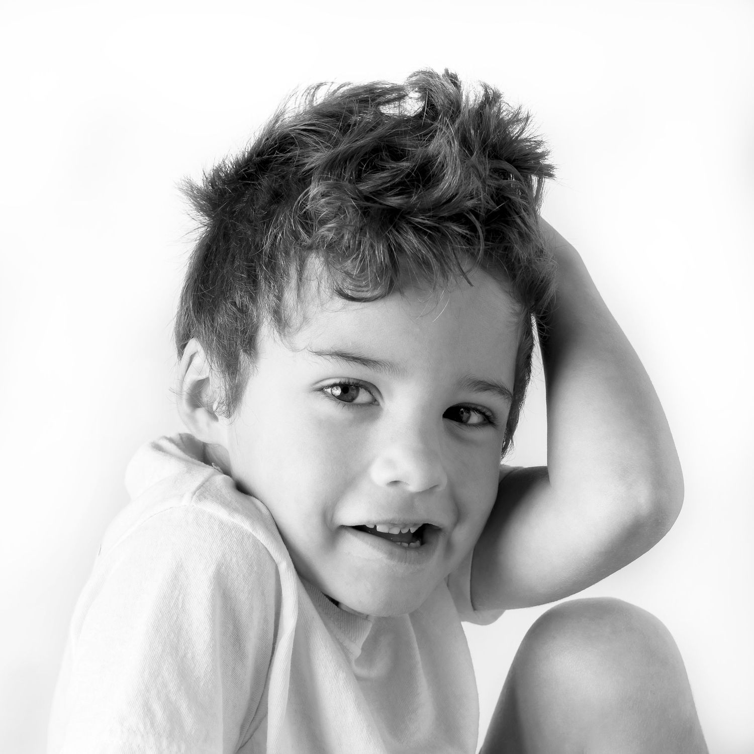Black-and-white portrait of happy young boy at Classic Littles children's portrait session.