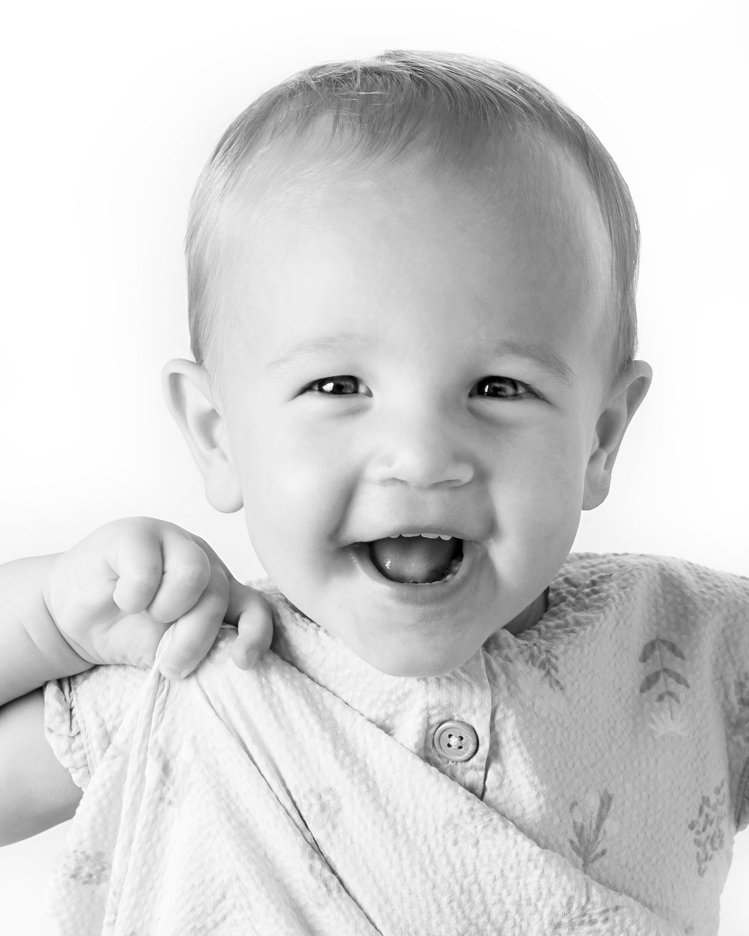 Black-and-white portrait of smiling young girl at Classic Littles children's portrait session.