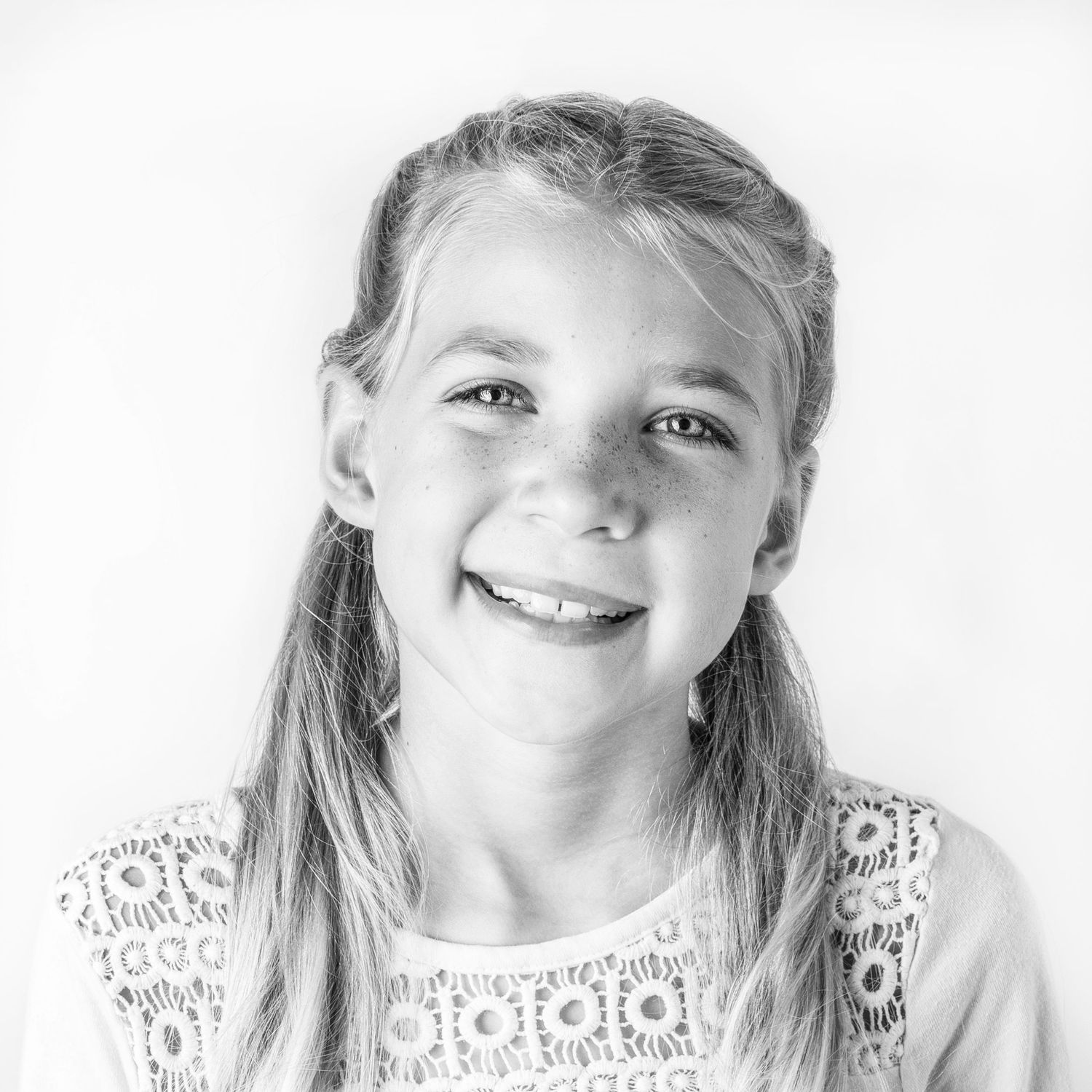 Black-and-white portrait of happy girl at Classic Littles children's portrait session.