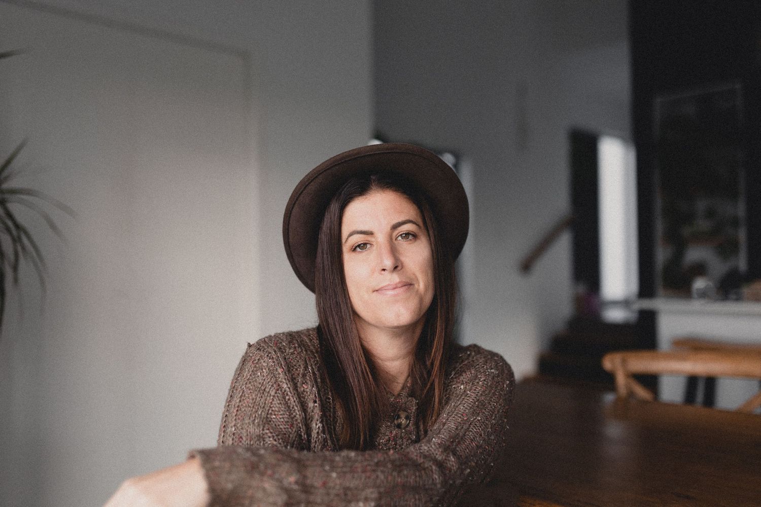 Minimalist indoor portrait with soft natural window lighting.