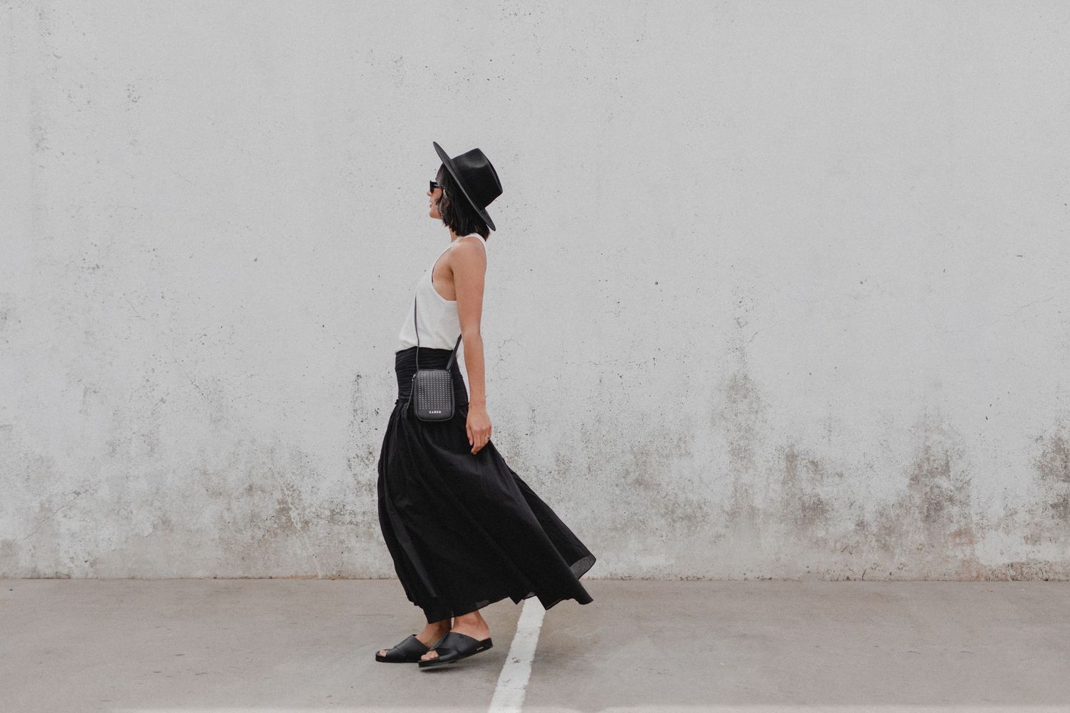 Artistic black and white fashion photograph with flowing dress movement.