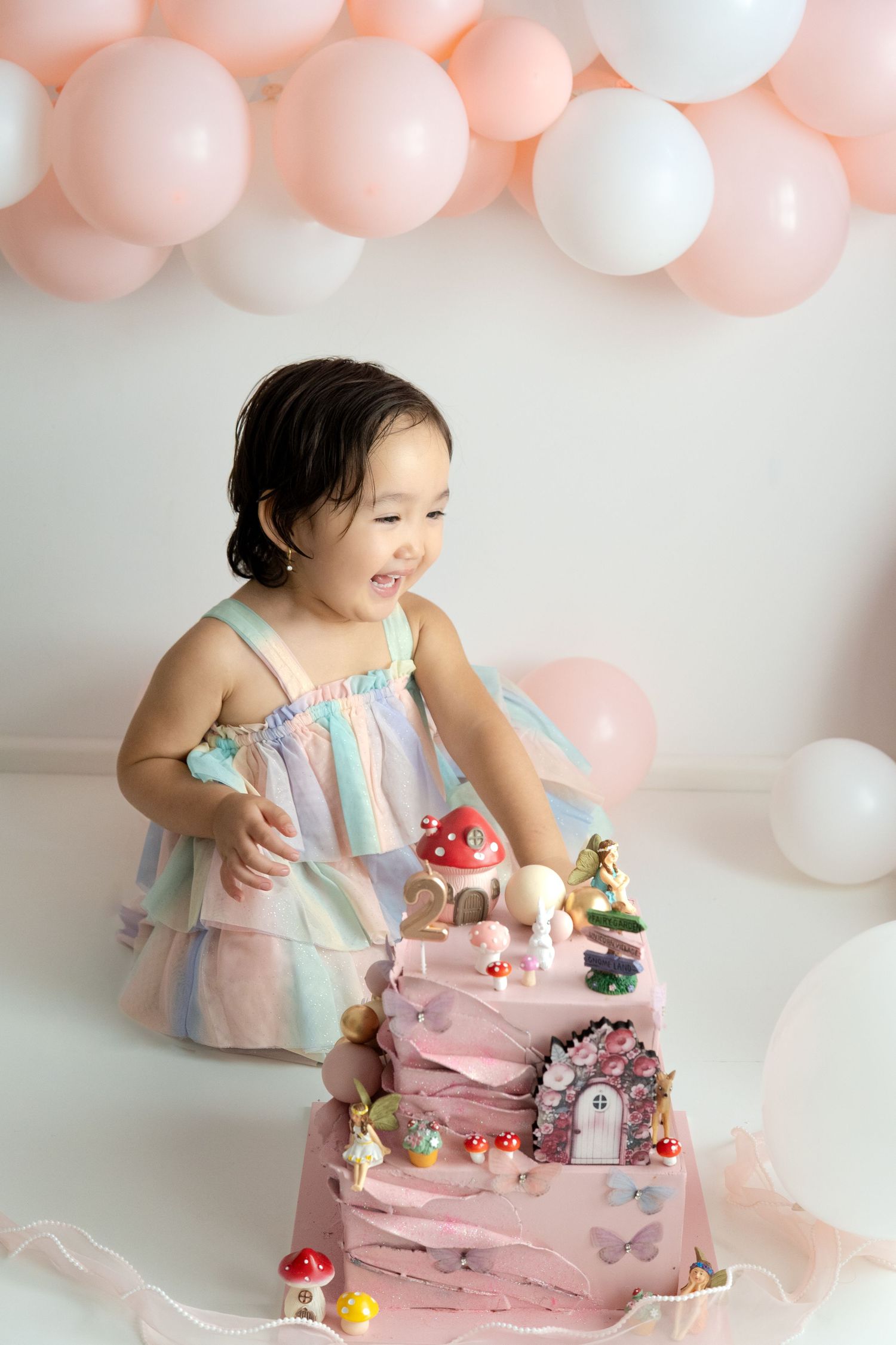 Baby celebrating their first birthday during a cake smash photography session in Melbourne.