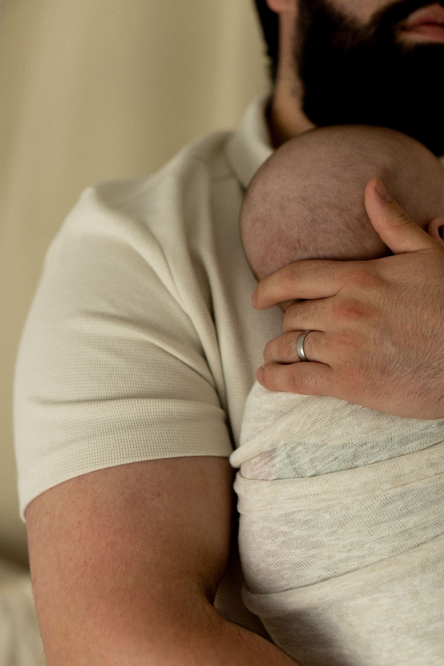 father holding newborn son