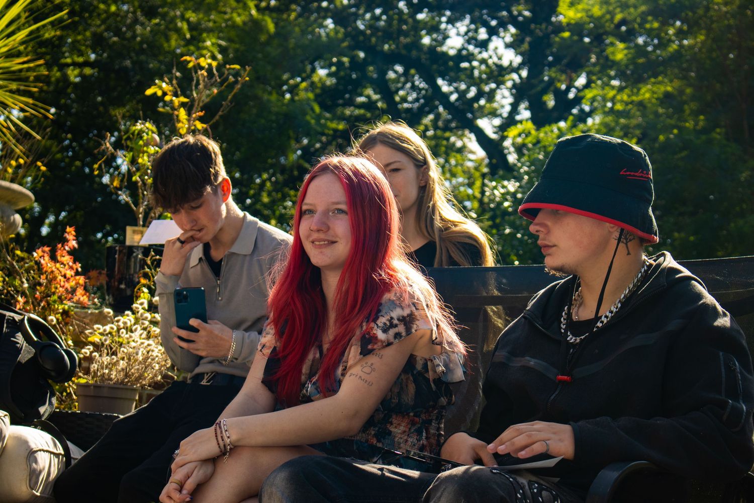 Group of people sitting together outdoors during golden hour.