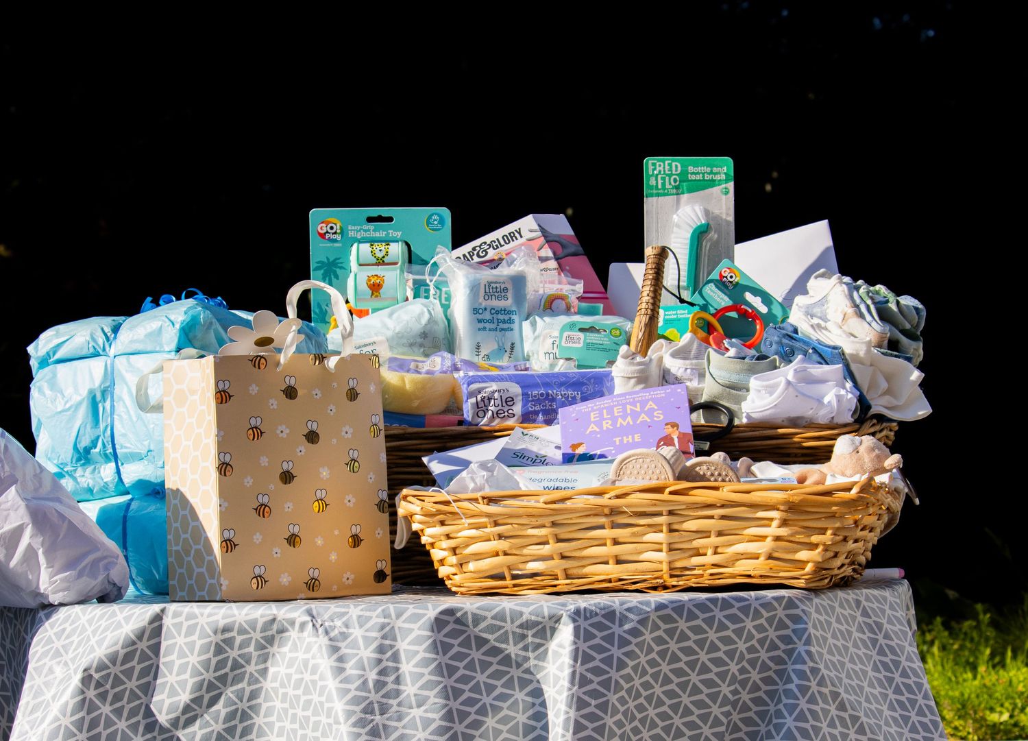 Baby shower gift basket filled with diapers, wipes and baby essentials.