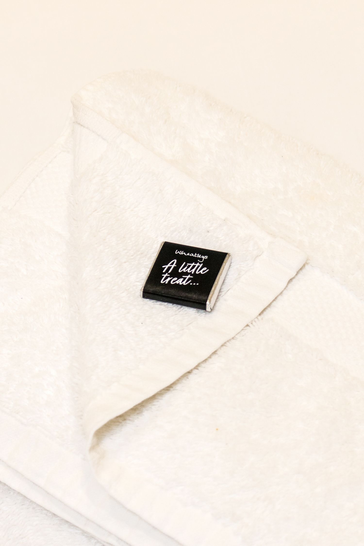 Close-up of white textured fabric with black label tag.