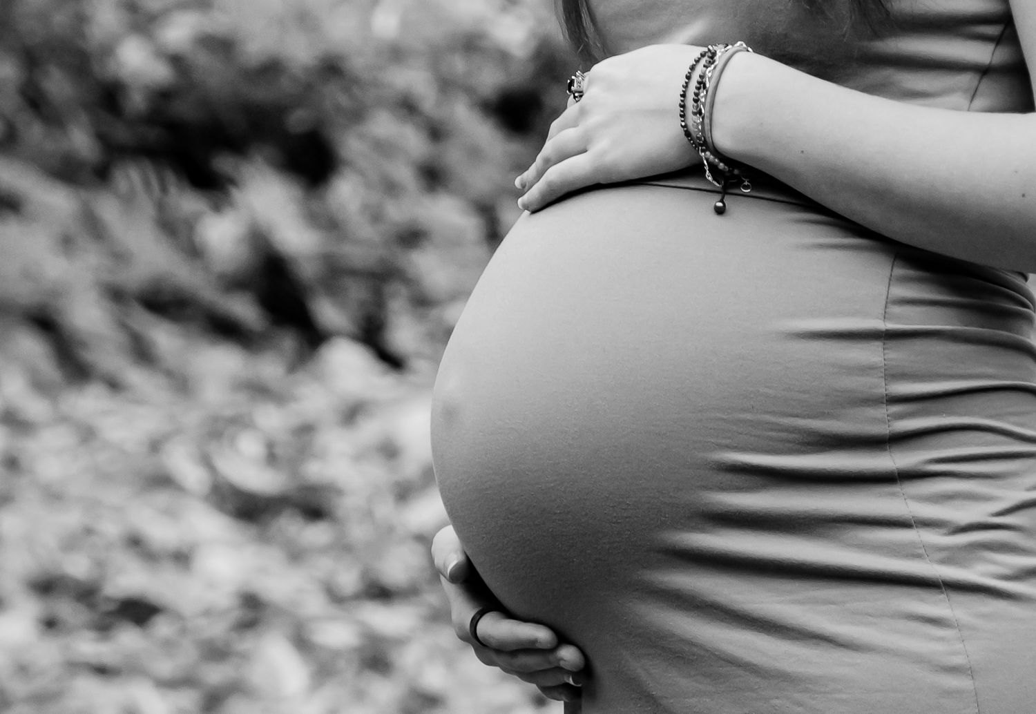 A sequence of maternity photos showing a growing baby bump in silhouette.
