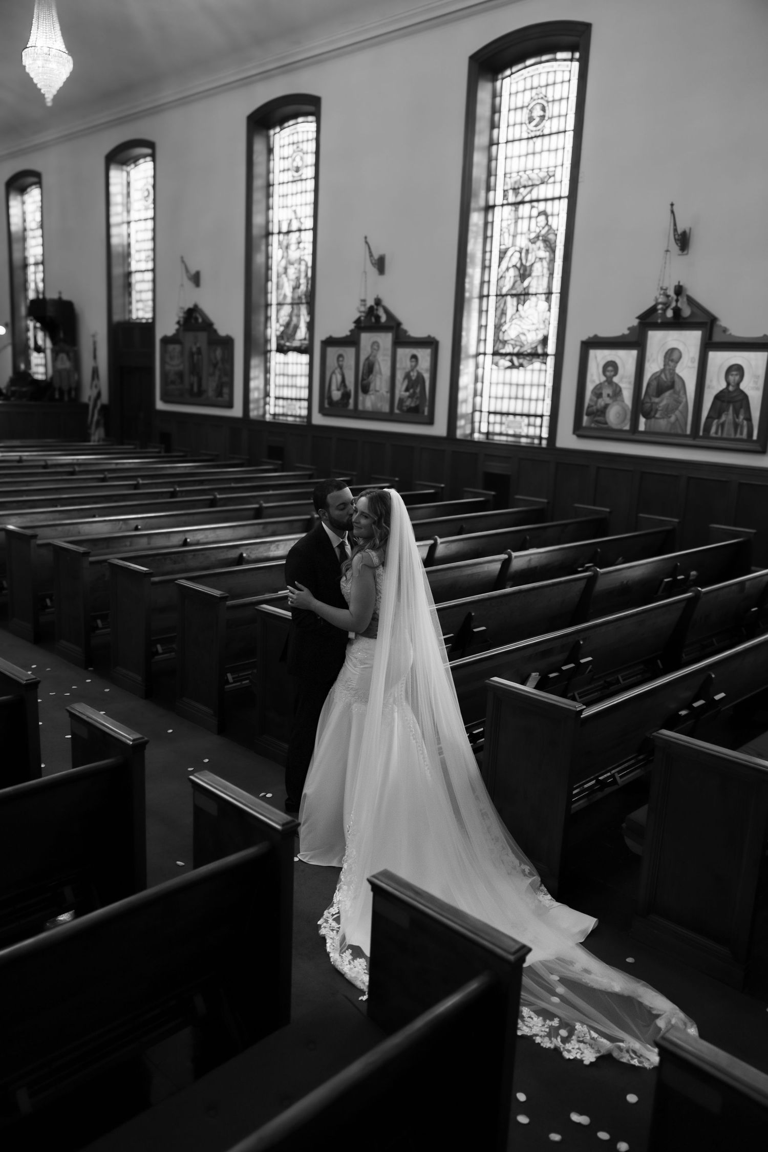 bride and groom inside of church black and white