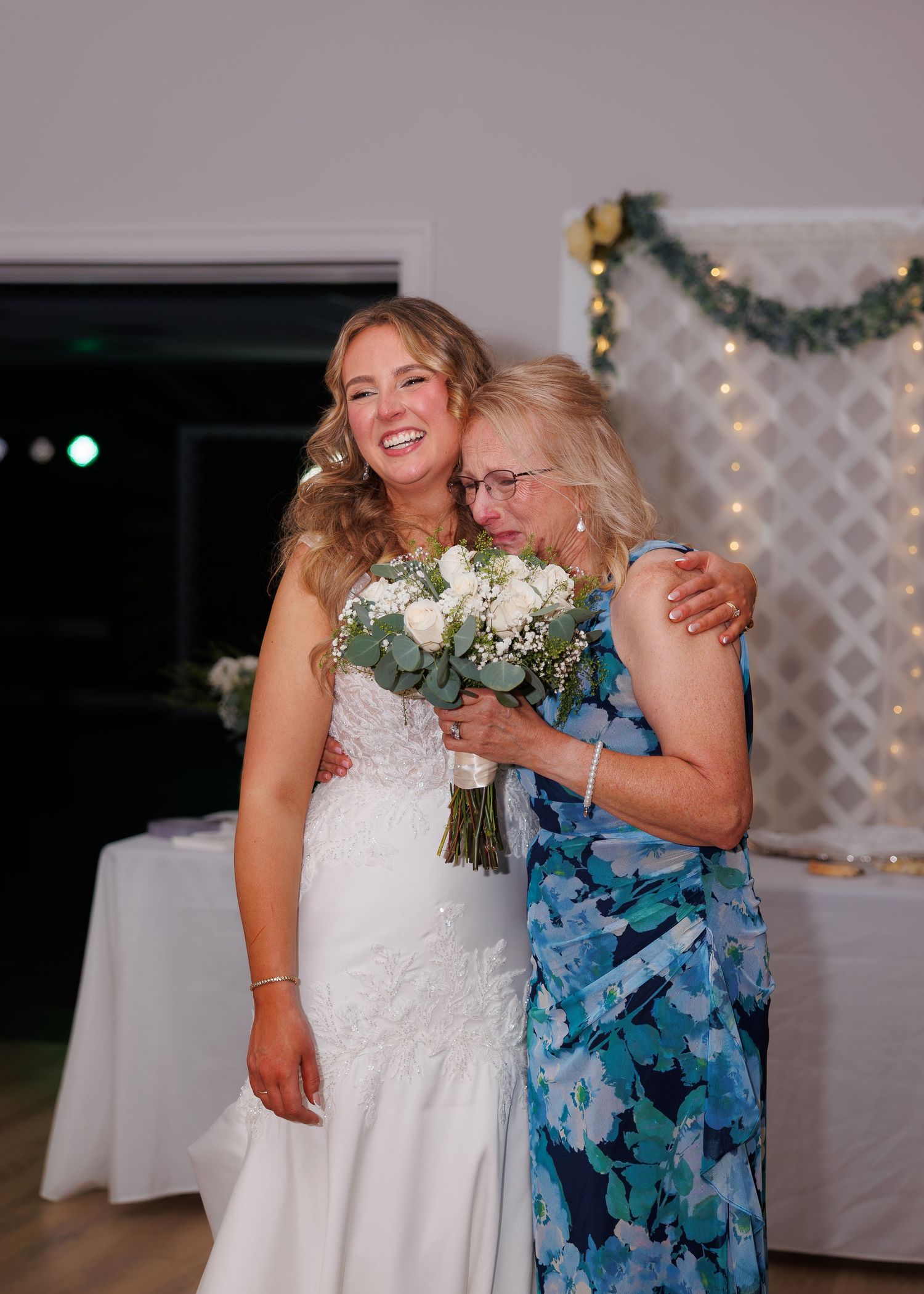 mother of bride crying happy next to bride