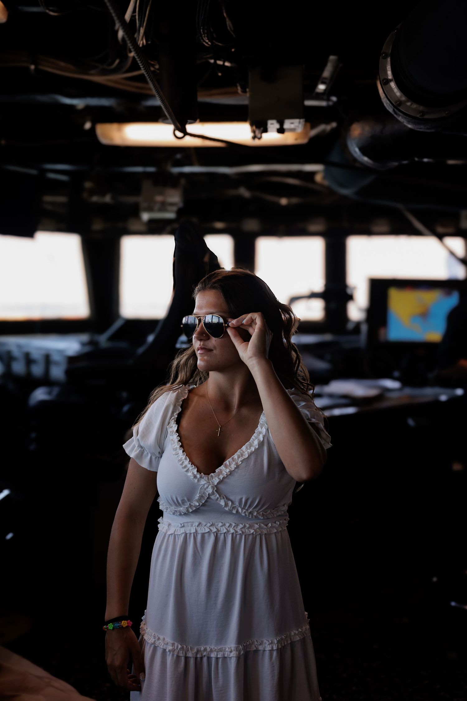 girl on ship with glasses looking out to the water
