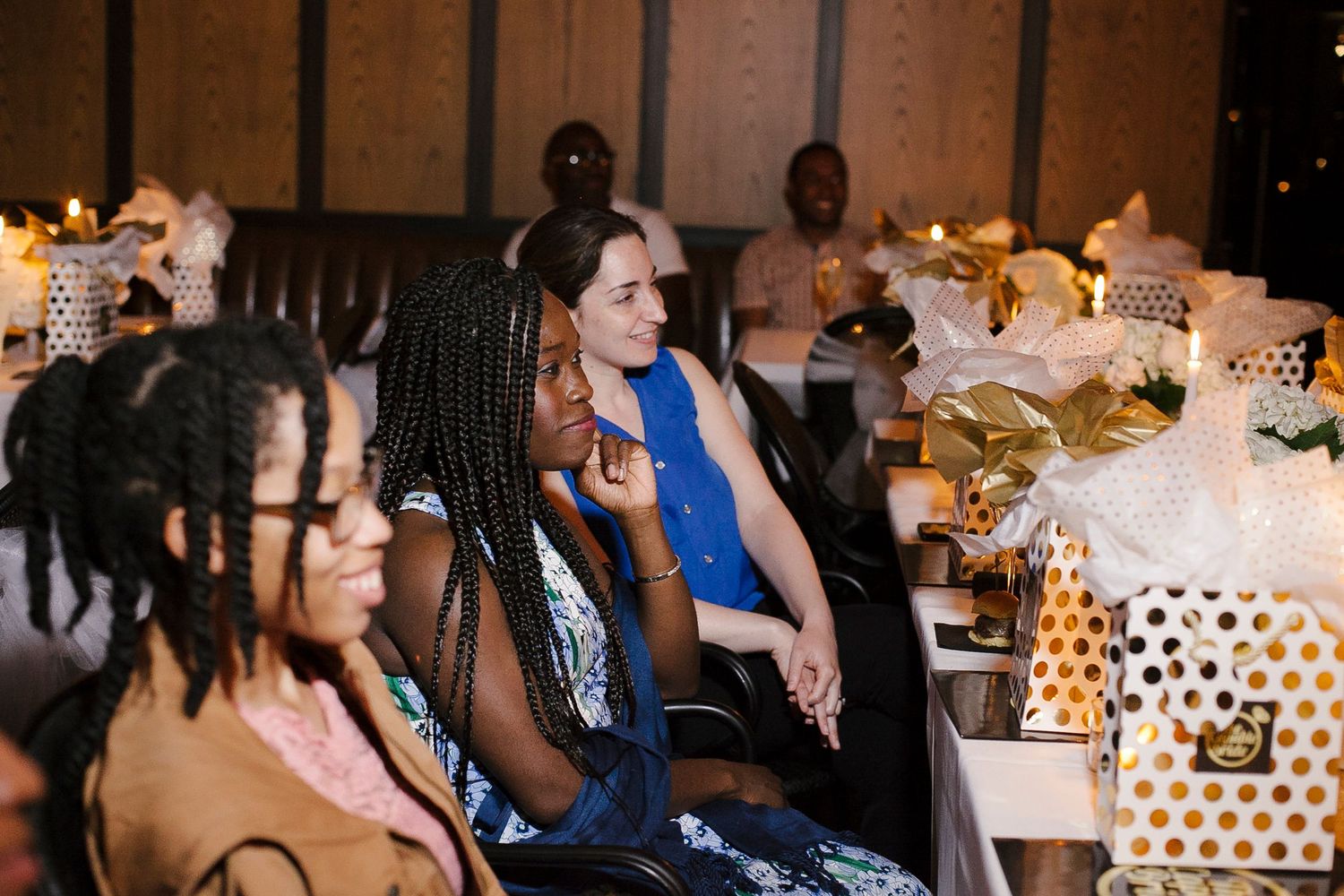 Diverse group of women attentively seated at The Capable Bride wedding planning event with gift bags.