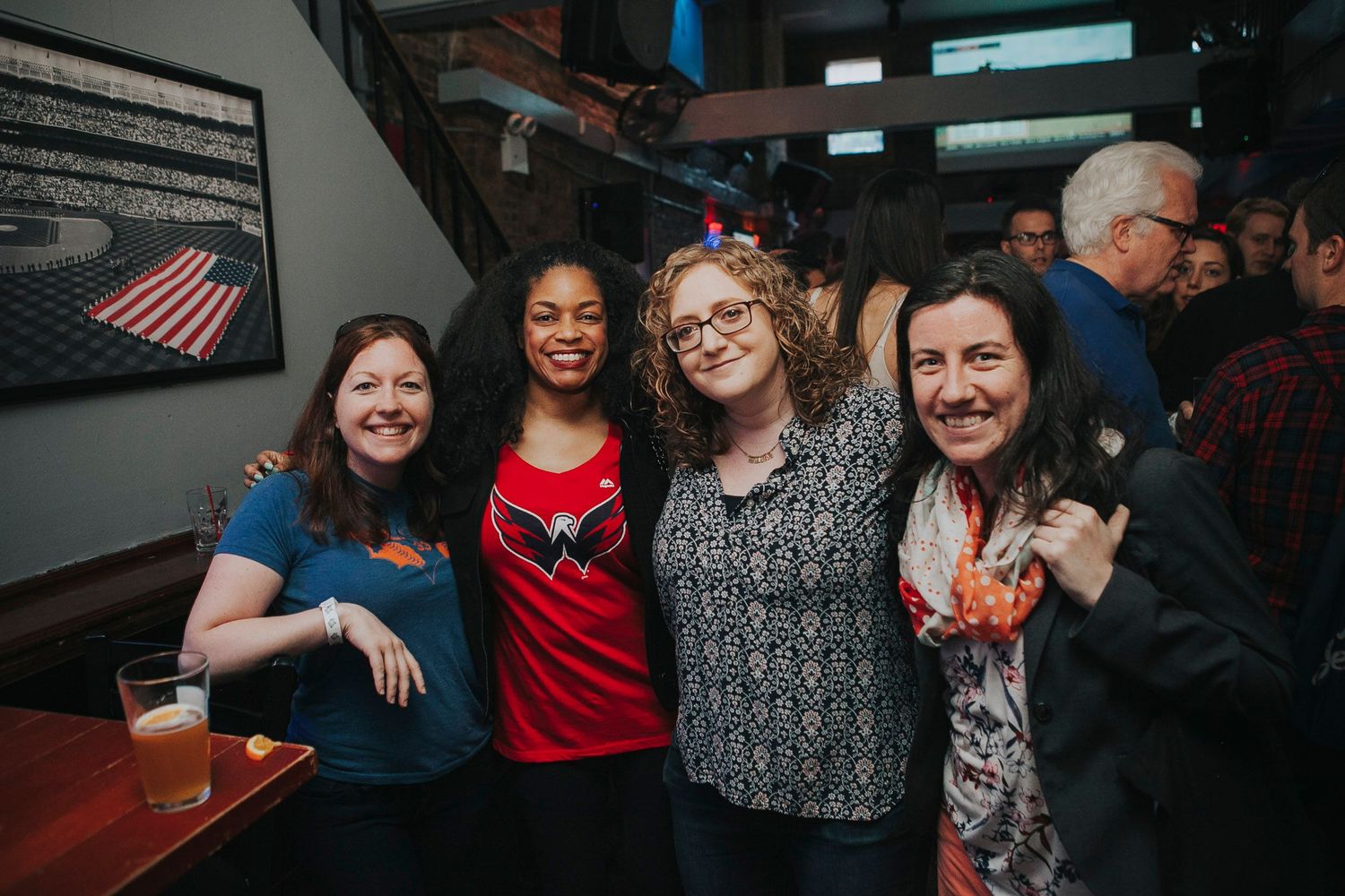 Four women smile and pose together at Turtle Bay NYC bar event.