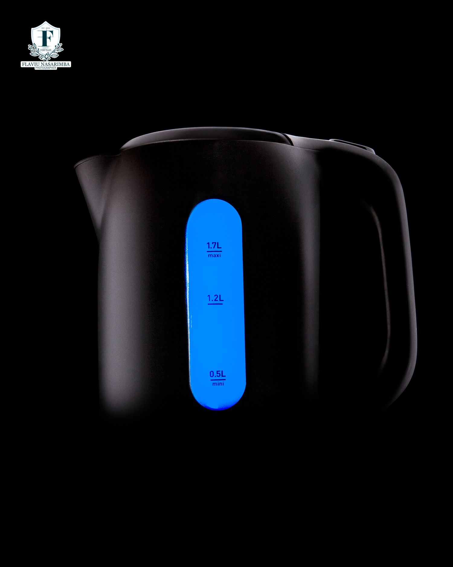 Black electric kettle with illuminated blue water level indicator showing measurement markings.