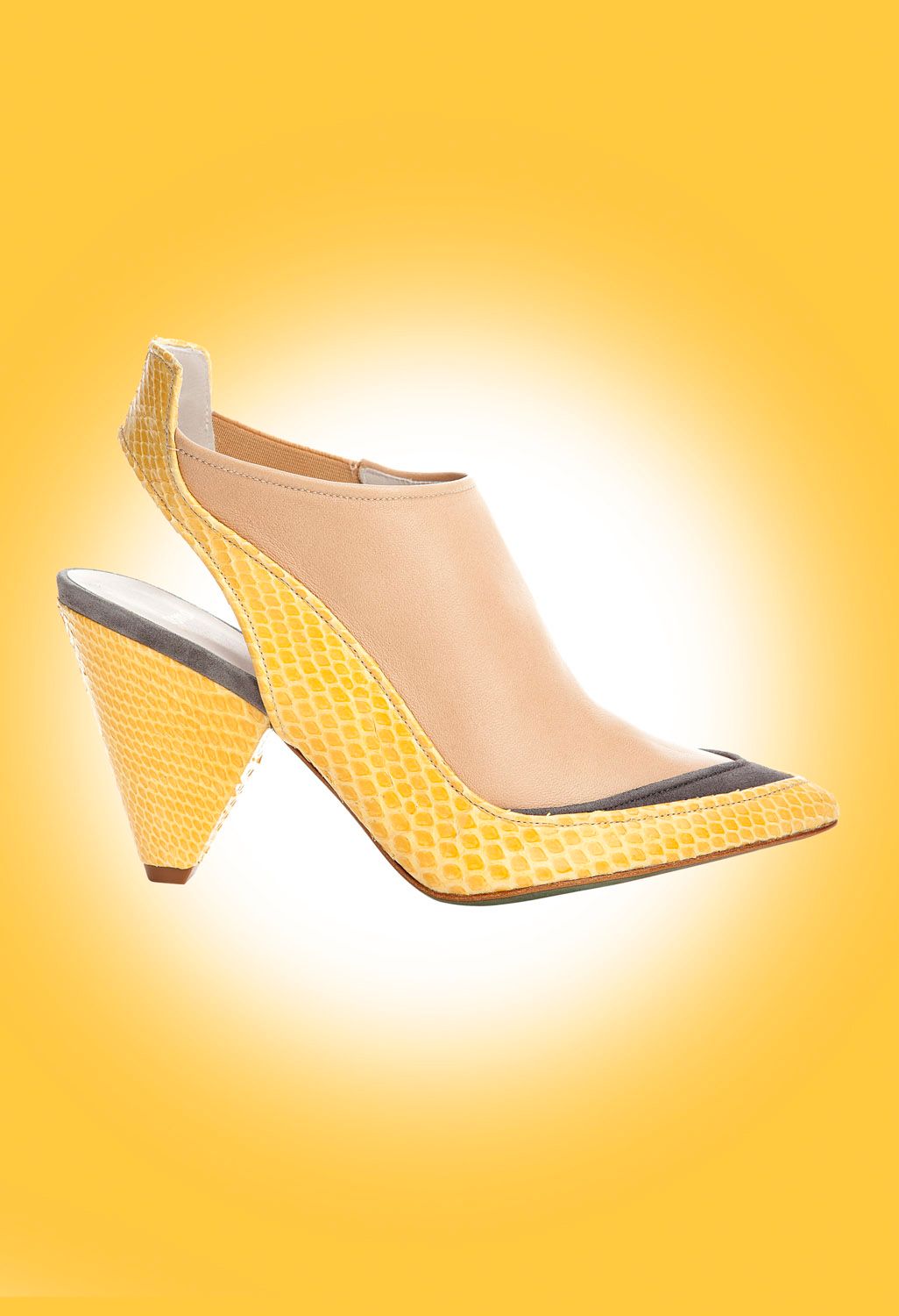 Yellow snakeskin slingback heels with nude panel and black cap toe on bright yellow background.