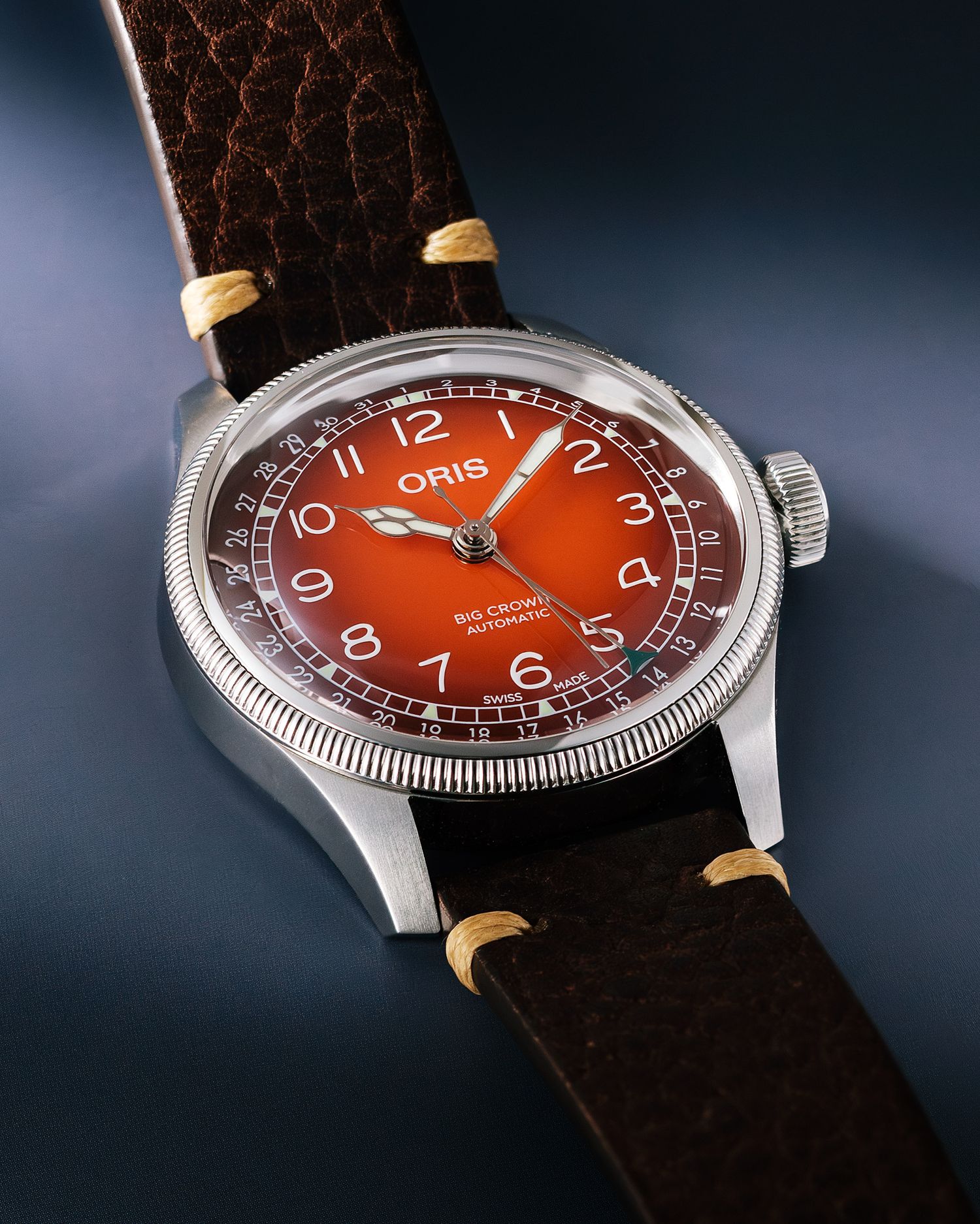 Oris Big Crown Pointer Date automatic watch with burnt orange dial on brown leather strap.