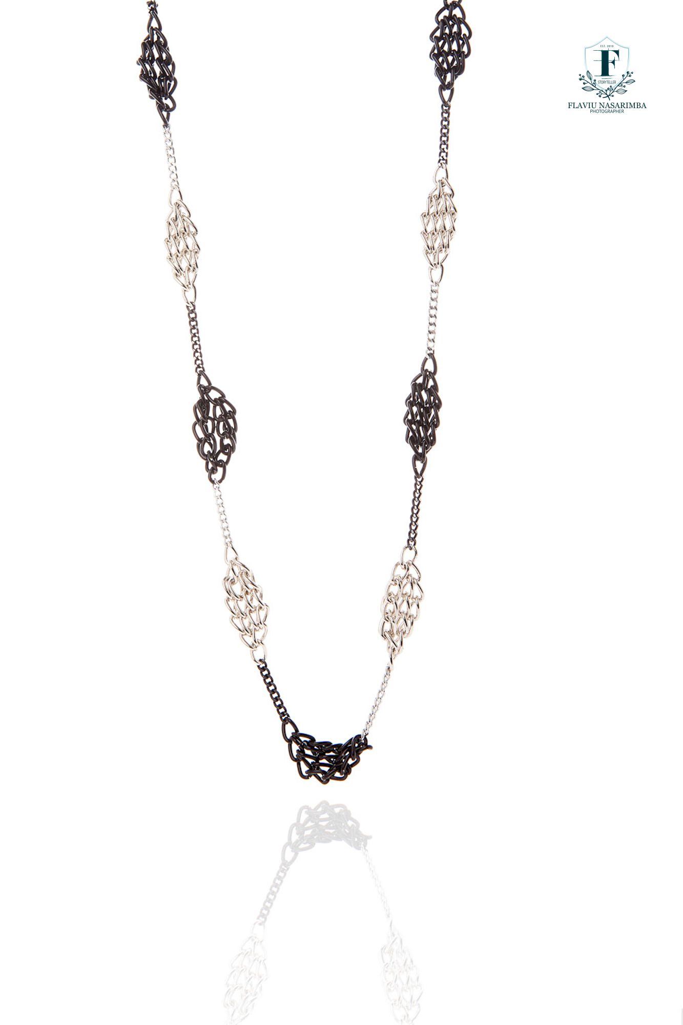 Two-tone necklace alternating black lace-style woven oval links with silver chain segments.
