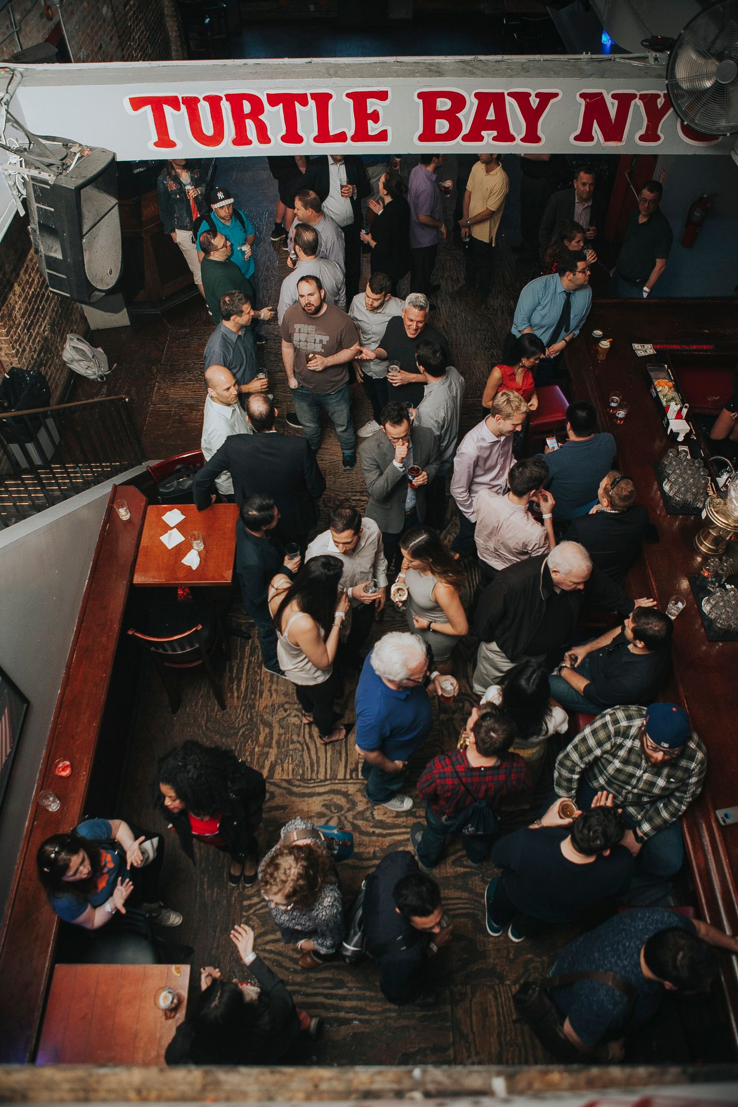 Aerial view of crowded Turtle Bay NYC bar filled with event guests.