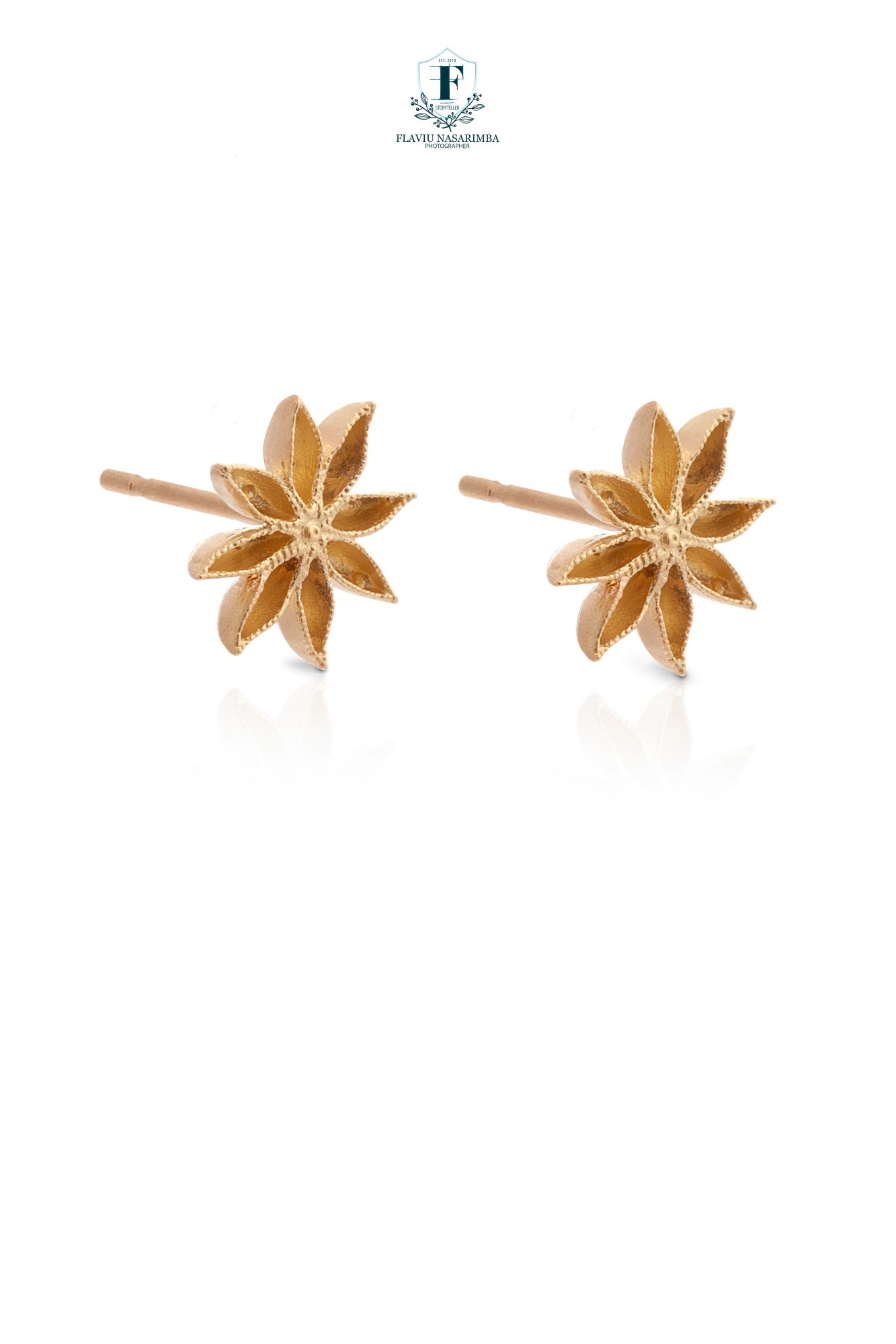 Pair of delicate gold star anise flower stud earrings on white background by Flavio Narareba.