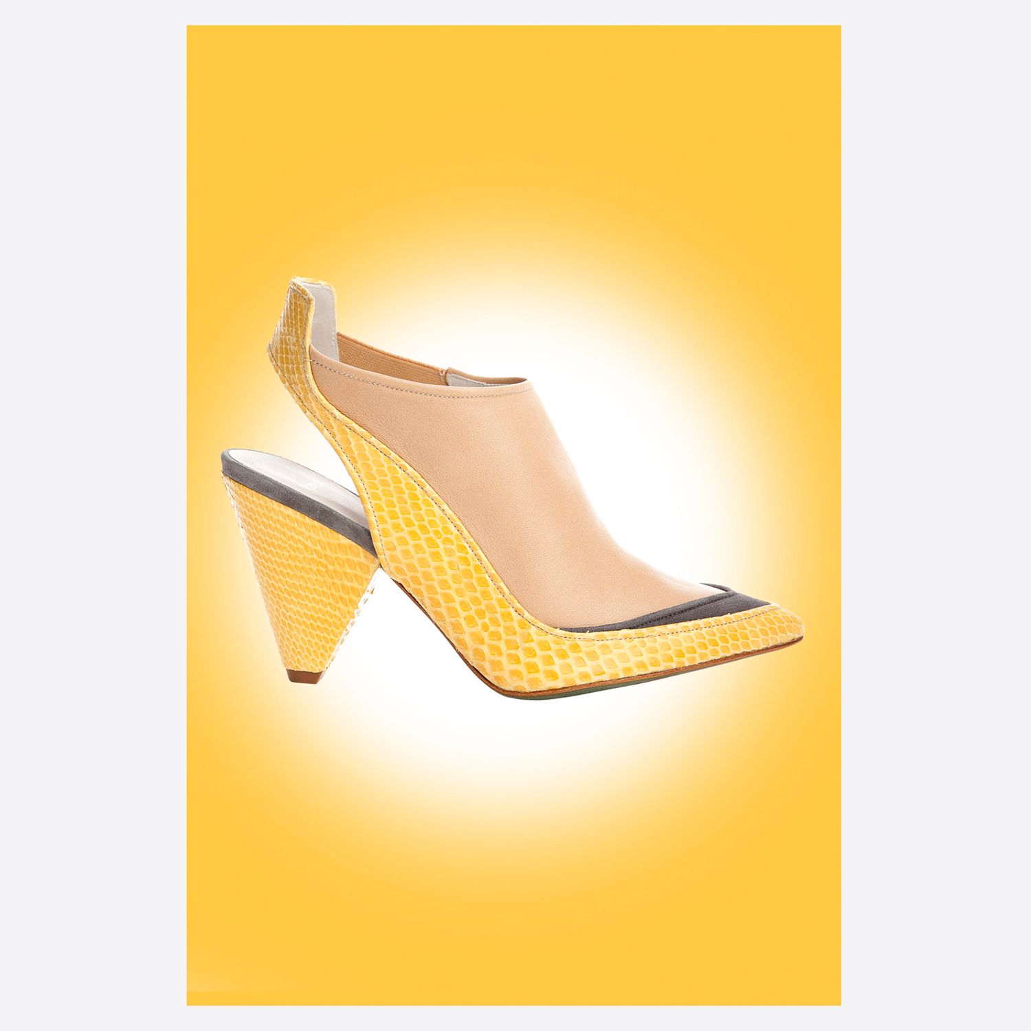 Yellow snakeskin slingback heels with navy toe cap and nude mesh panel on bright yellow background.