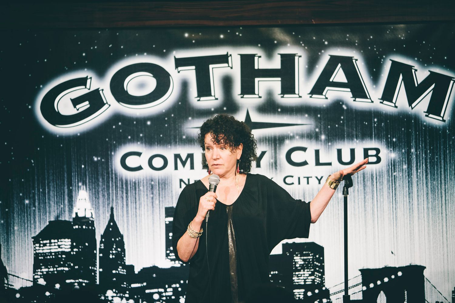 Comedian performing stand-up on stage at Gotham Comedy Club in New York City.