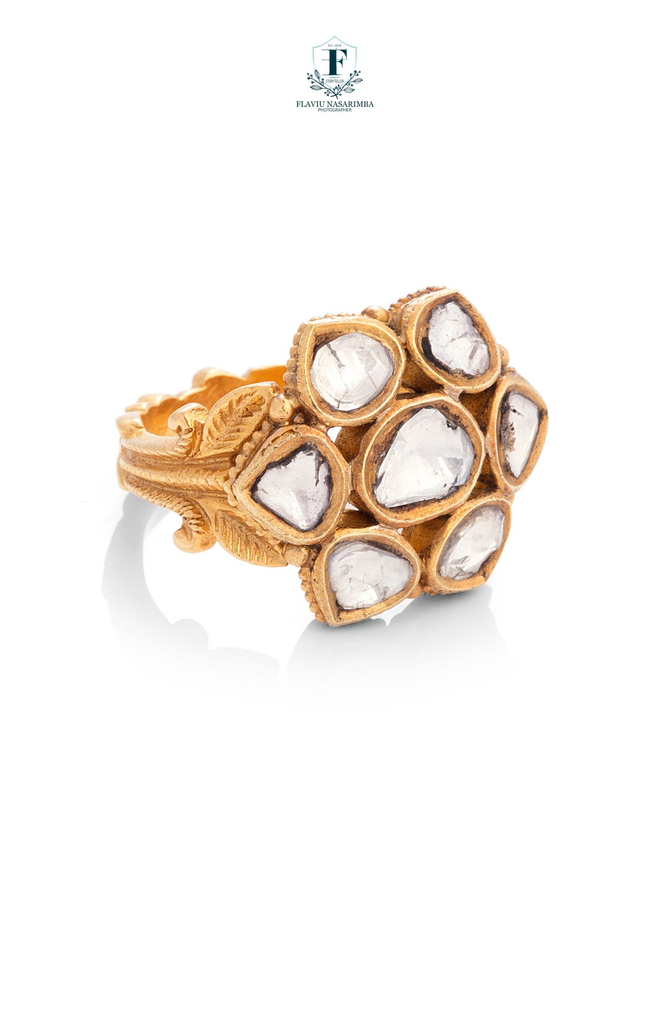 Gold kundan ring featuring seven polki diamonds in a floral cluster setting with intricate leaf detailing on the band.