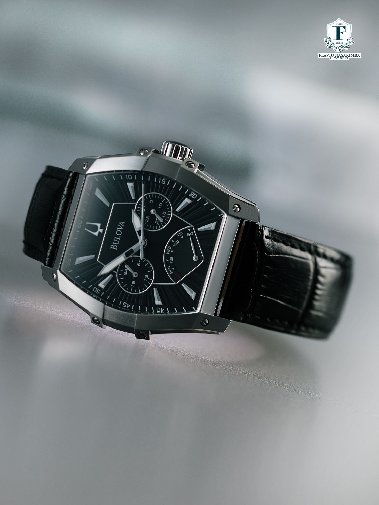Bulova black chronograph watch with tonneau case on black crocodile leather strap.