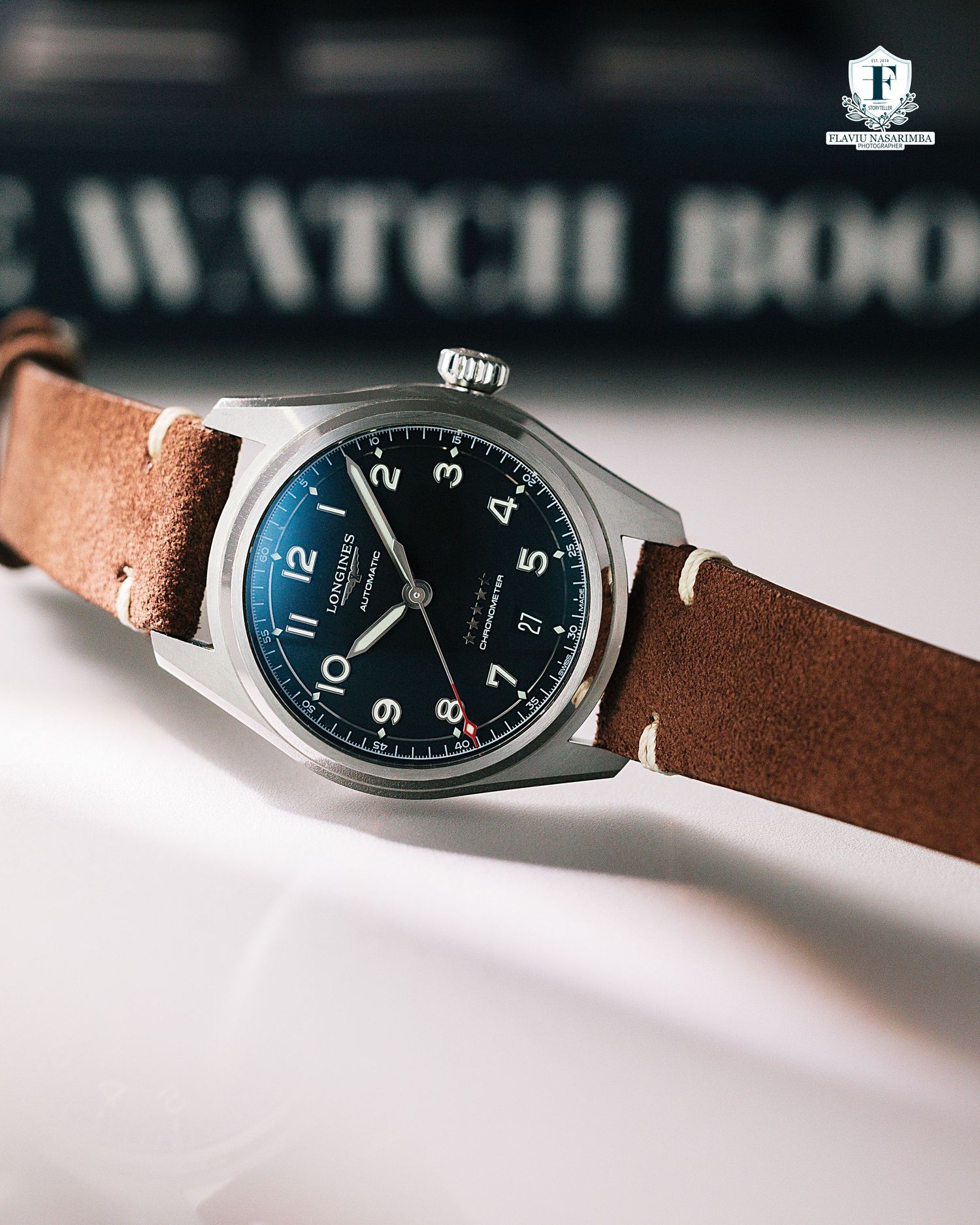 Longines Spirit automatic pilot watch with black dial on vintage brown leather strap.