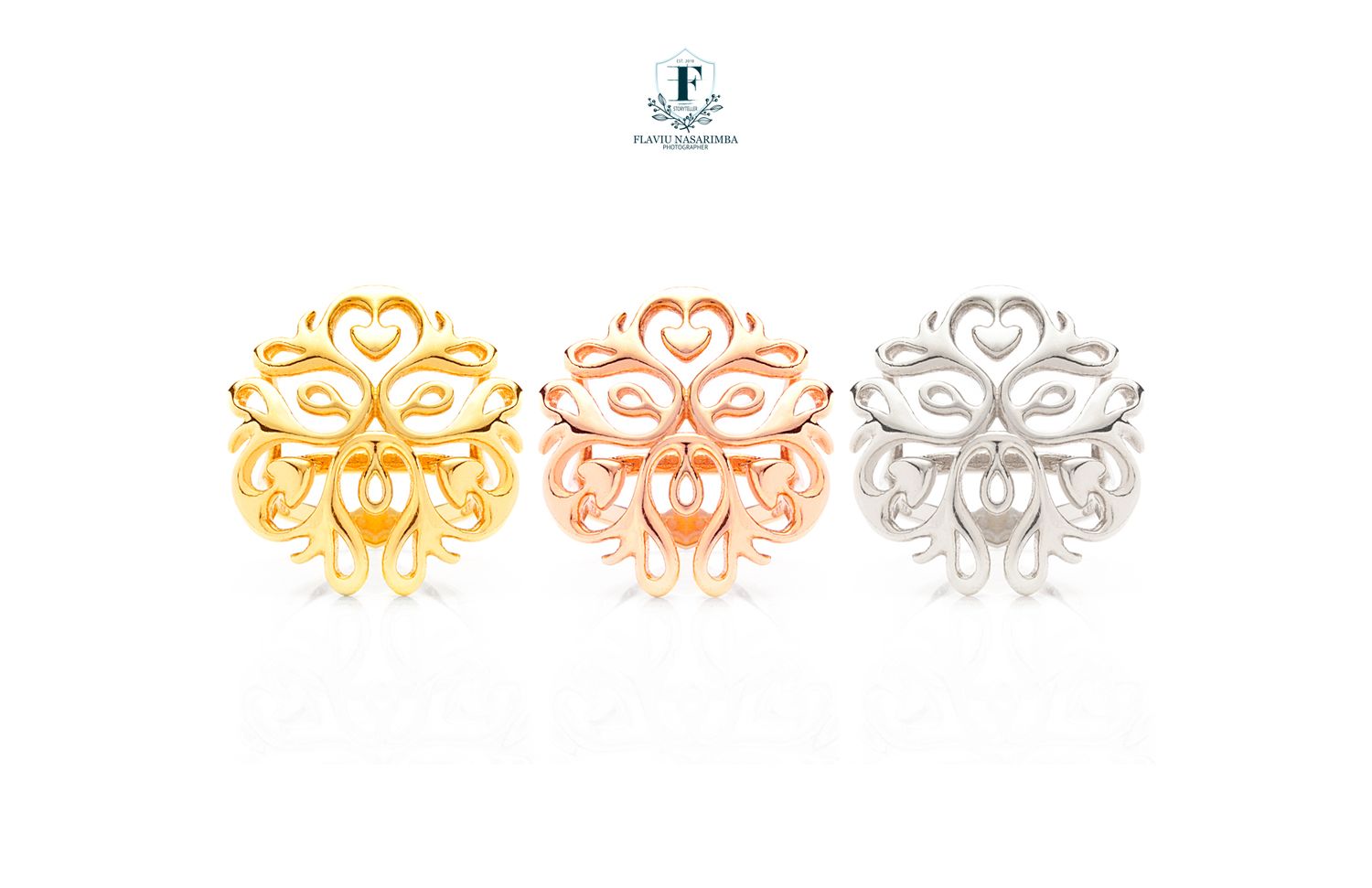 Three ornate filigree rings in gold, rose gold, and silver displayed on white background.