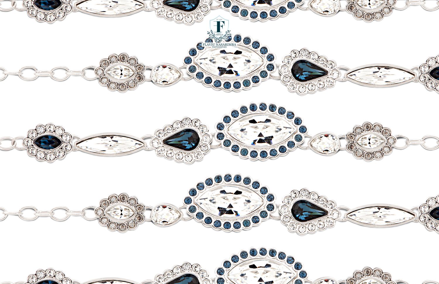 Silver bracelet with blue sapphire and clear crystal rhinestone oval and teardrop links in repeating pattern.