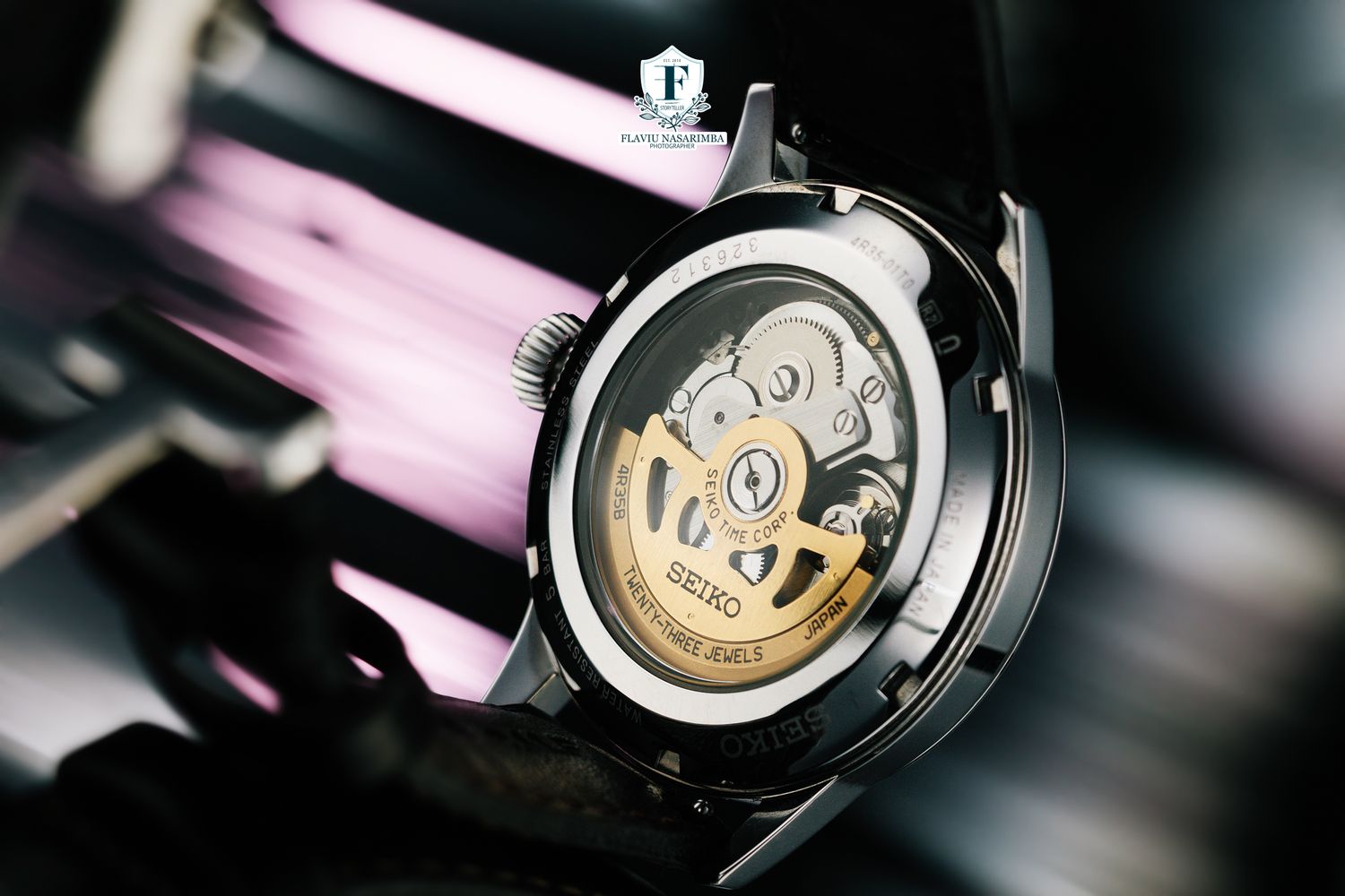 Close-up of a Seiko watch showcasing its intricate mechanical movement through a transparent caseback.