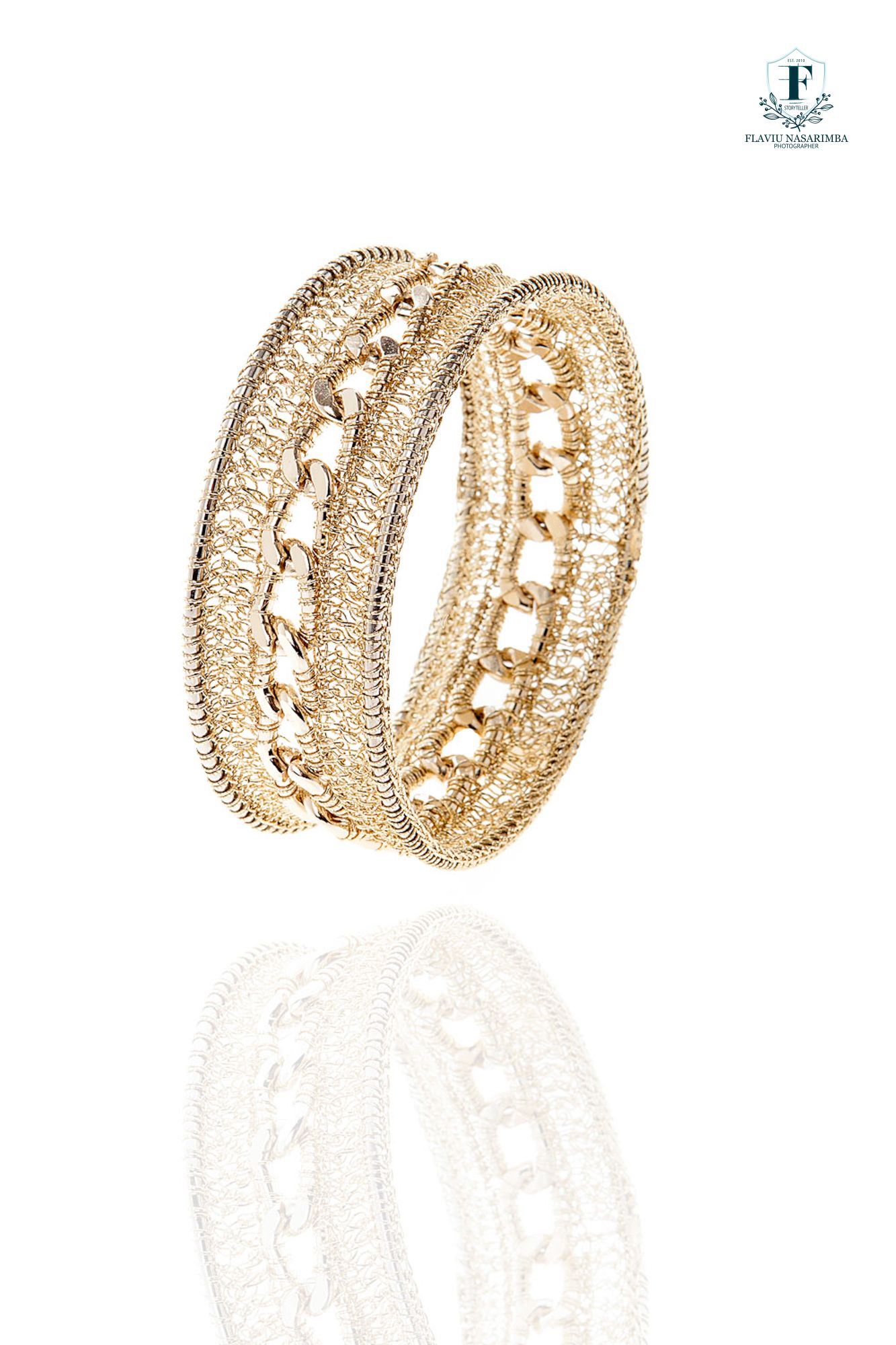 Ornate gold bangle bracelets with intricate chain and rope detailing on white background.