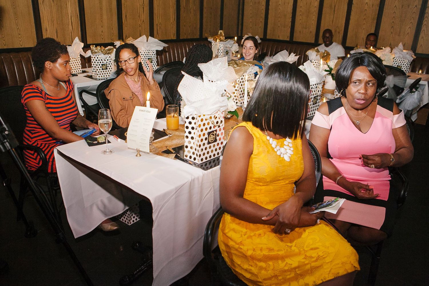 Guests seated at tables during The Capable Bride wedding planning seminar in a warmly lit venue.