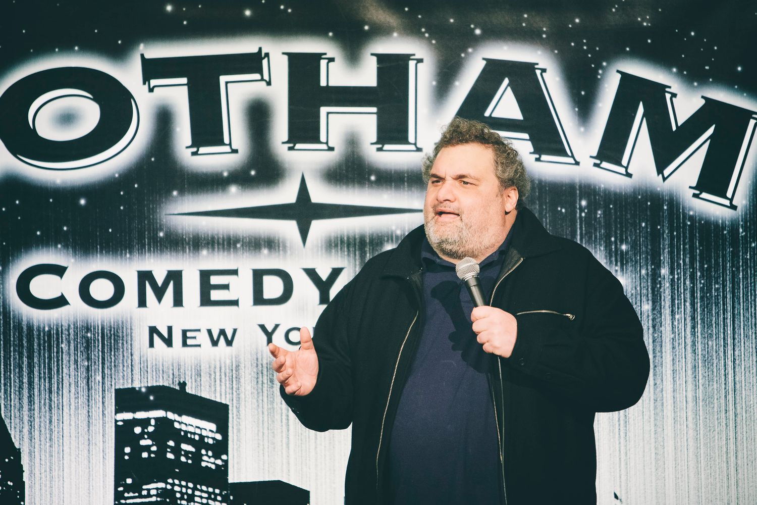 Heavyset male comedian performing stand-up at Gotham Comedy Club New York.