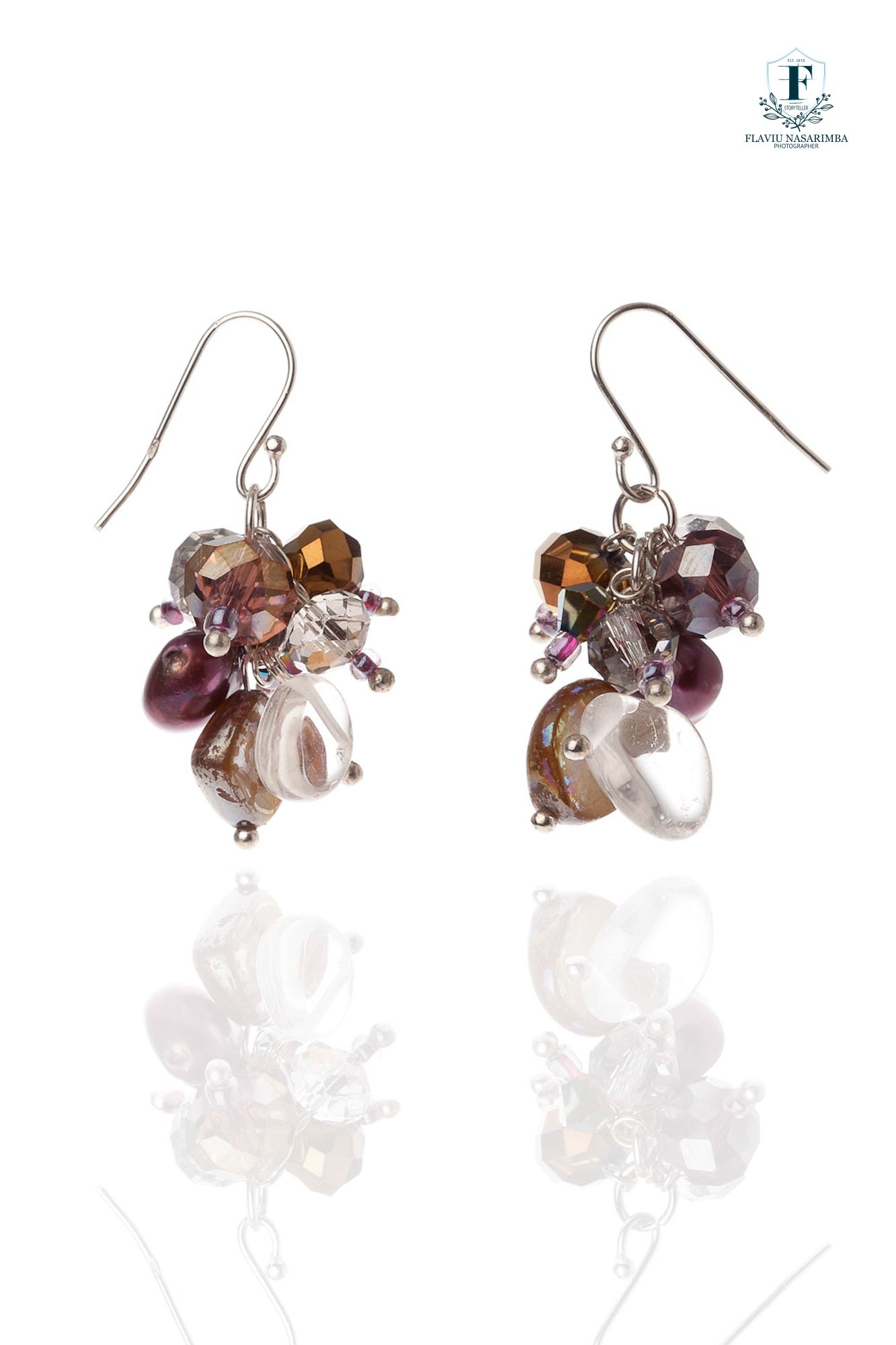Cluster drop earrings featuring purple crystals, pearls, and bronze beads on silver hooks.
