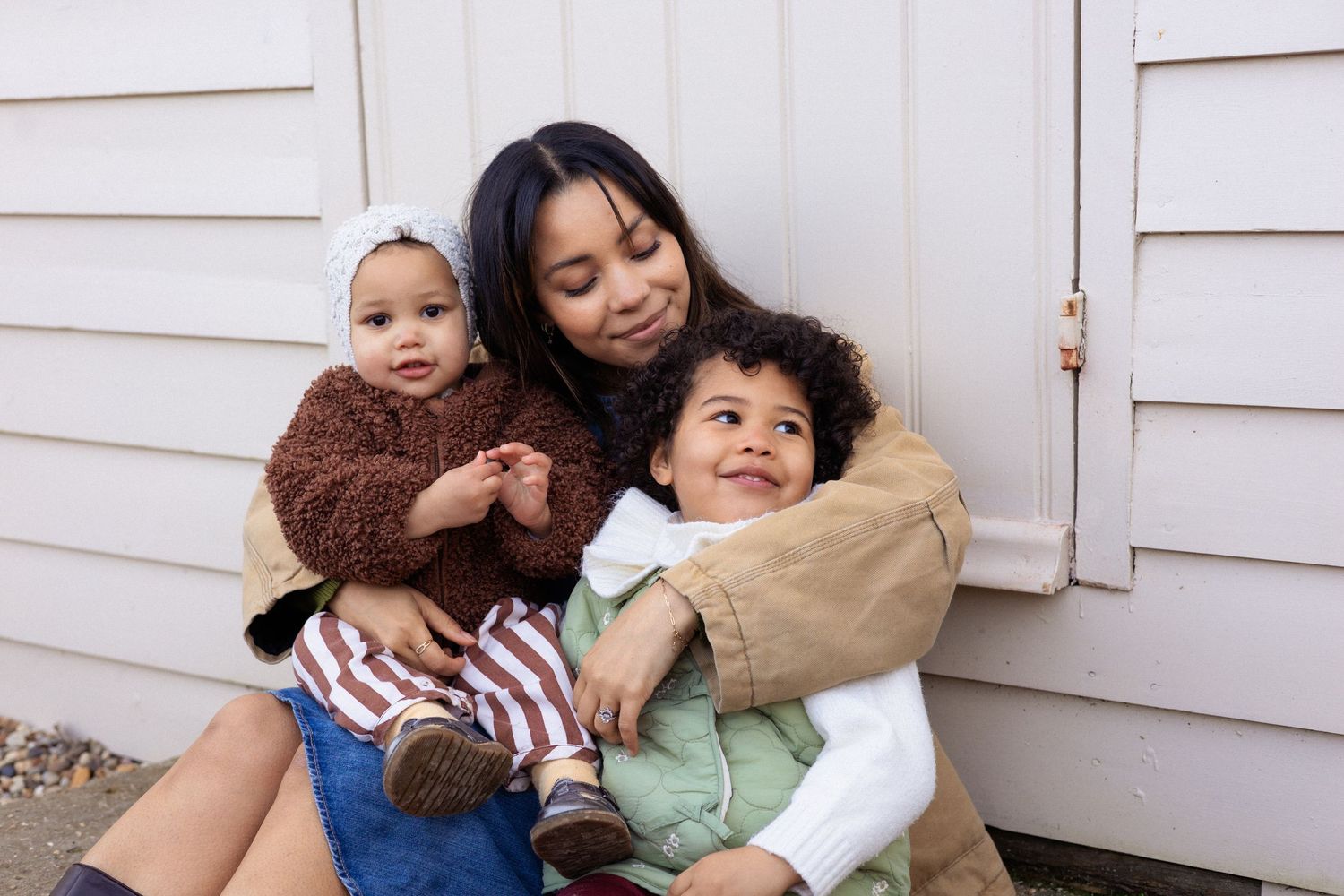 Family portrait photographer West London - mother with two babies, natural light outdoor session
