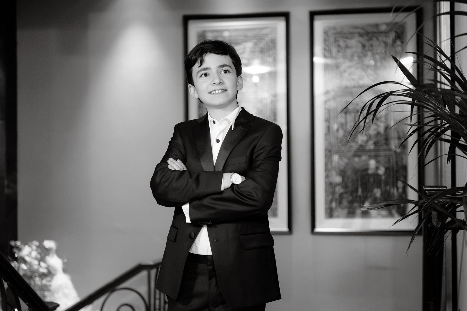 Professional headshots of people in business attire arranged in a row against a gray background with framed artwork.
