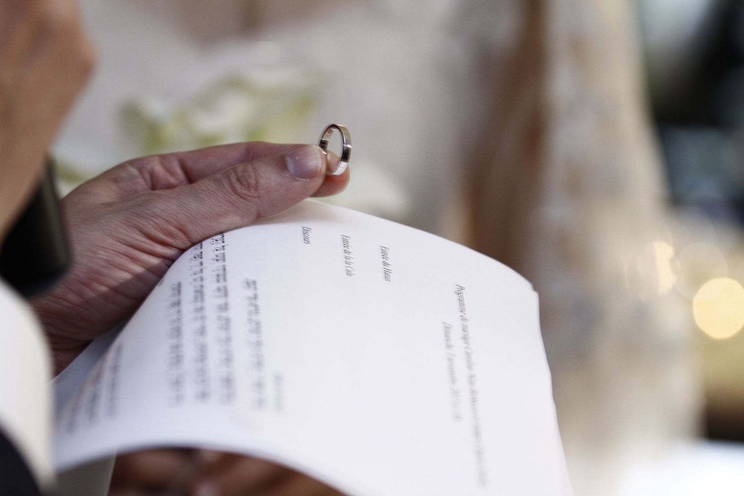 A close-up view of handwritten text on white paper with a blurred background.