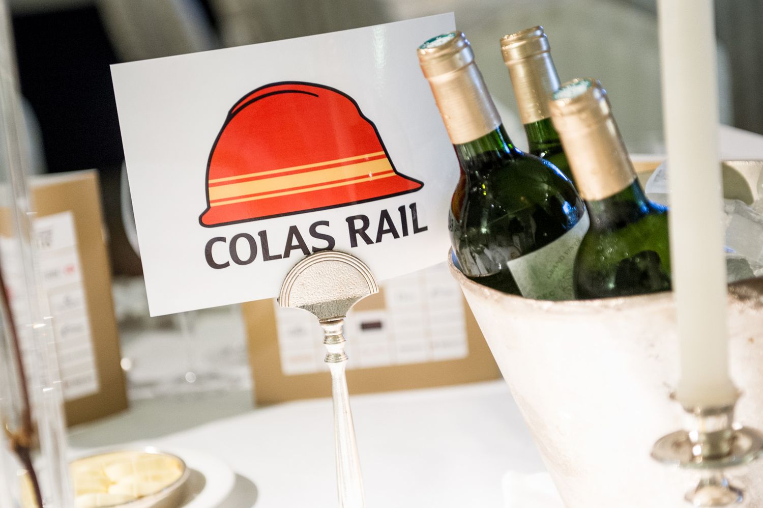 Corporate event setup with Colas Rail company branding visible.