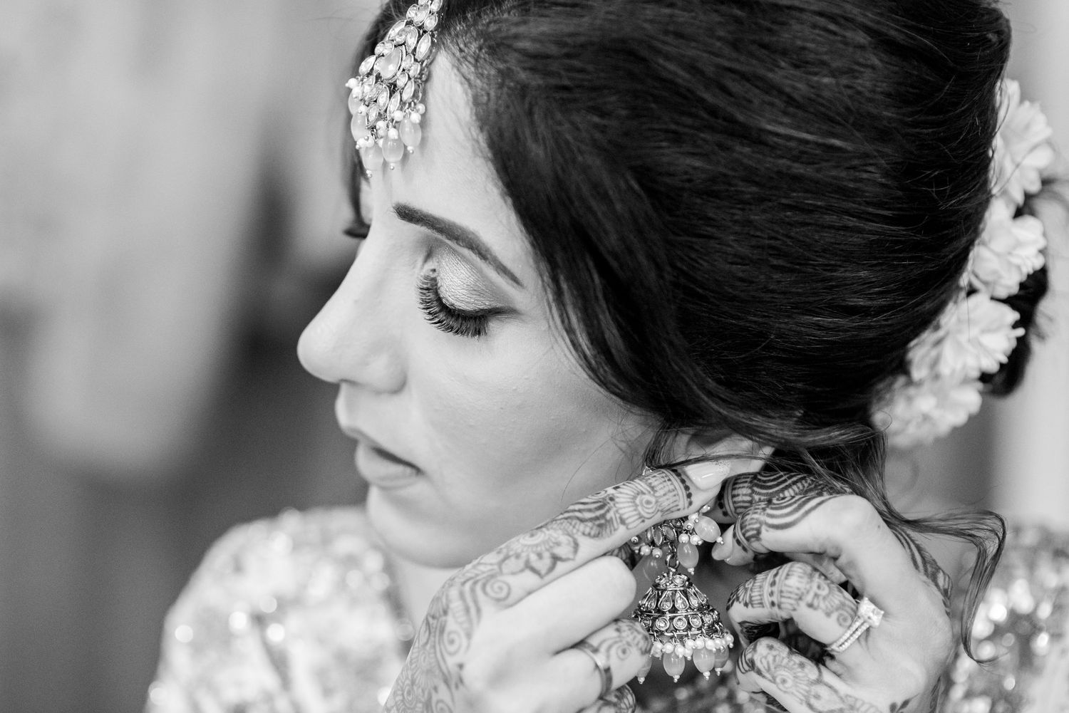 Black and white portrait series showing elegant bridal hair styling with delicate floral accessories and classic makeup.