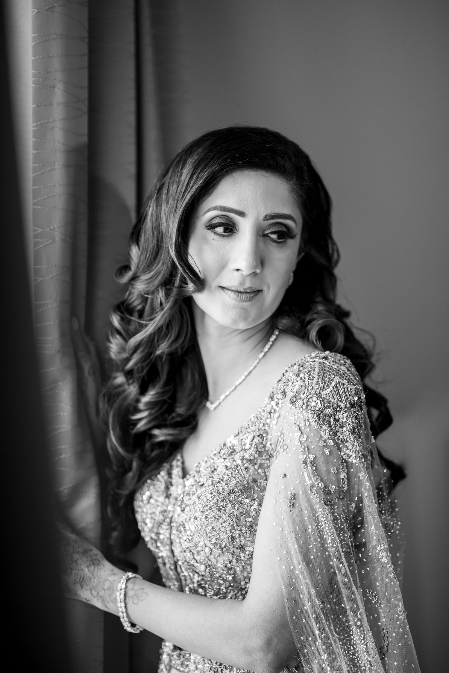 Black and white glamour portrait series showing elegant woman in sequined gown with styled curls against dark backdrop.