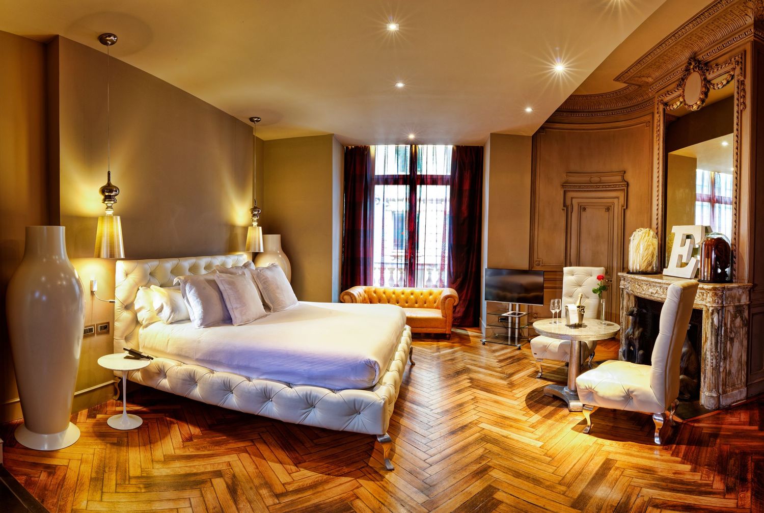 Luxurious hotel room interior with hardwood floors and elegant furnishings.